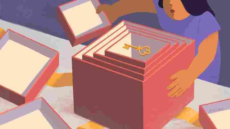 A woman opens a box that's filled with other, increasingly smaller boxes. Inside the smallest box, there's a key.