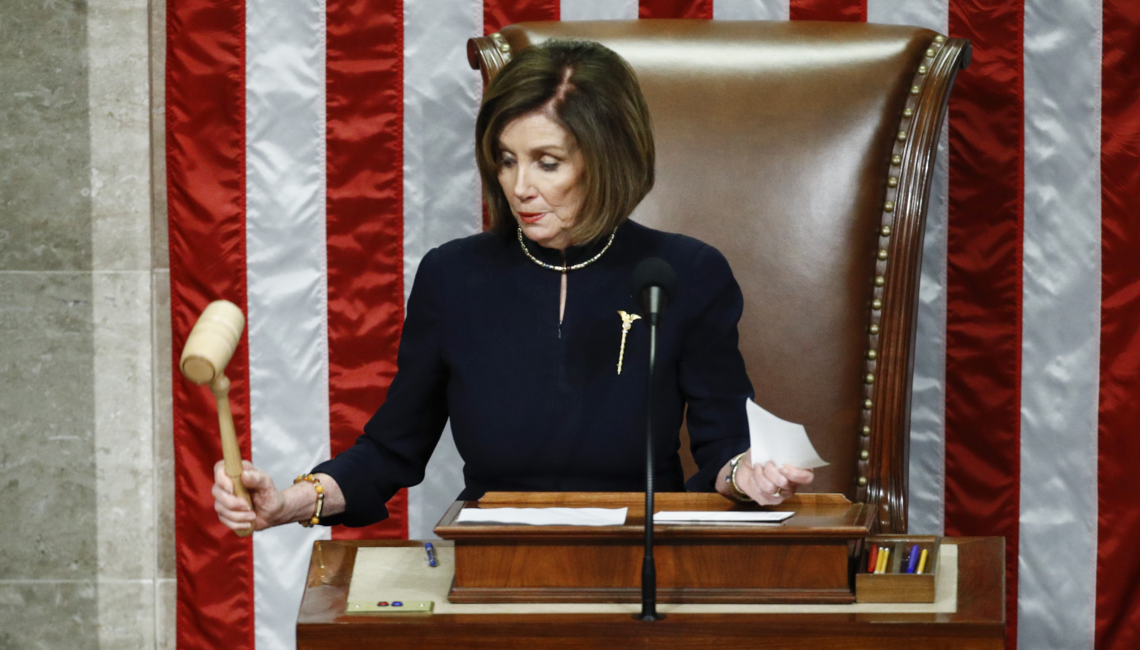 House Speaker Nancy Pelosi of California strikes the gavel after announcing the passage of article II of impeachment against President Trump on Wednesday. (AP)