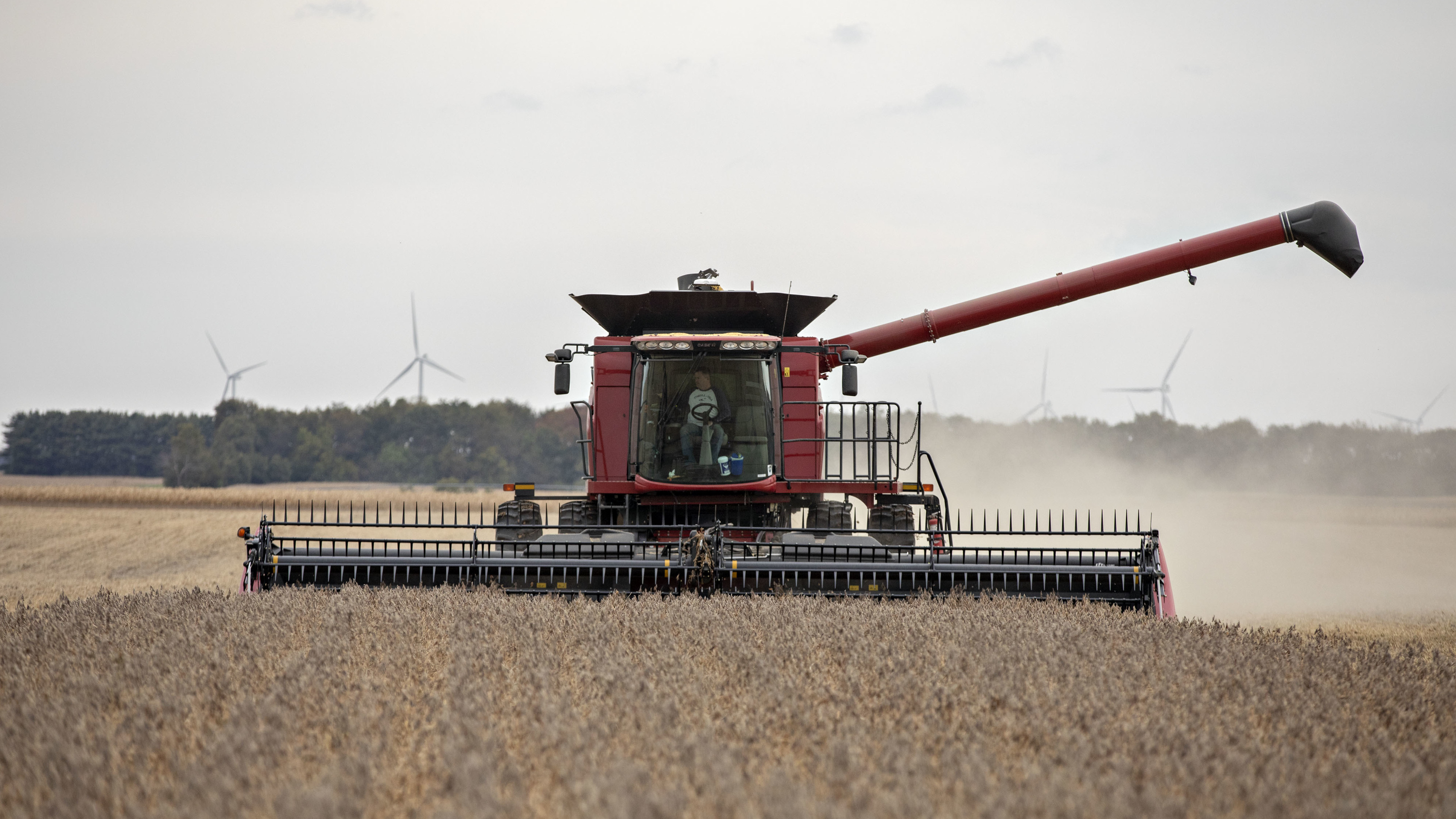 A farmer operates a combine to harvest soybeans in Wyanet, Ill. Farmers got more than $22 billion in government payments in 2019. It's the highest level of farm subsidies in 14 years.