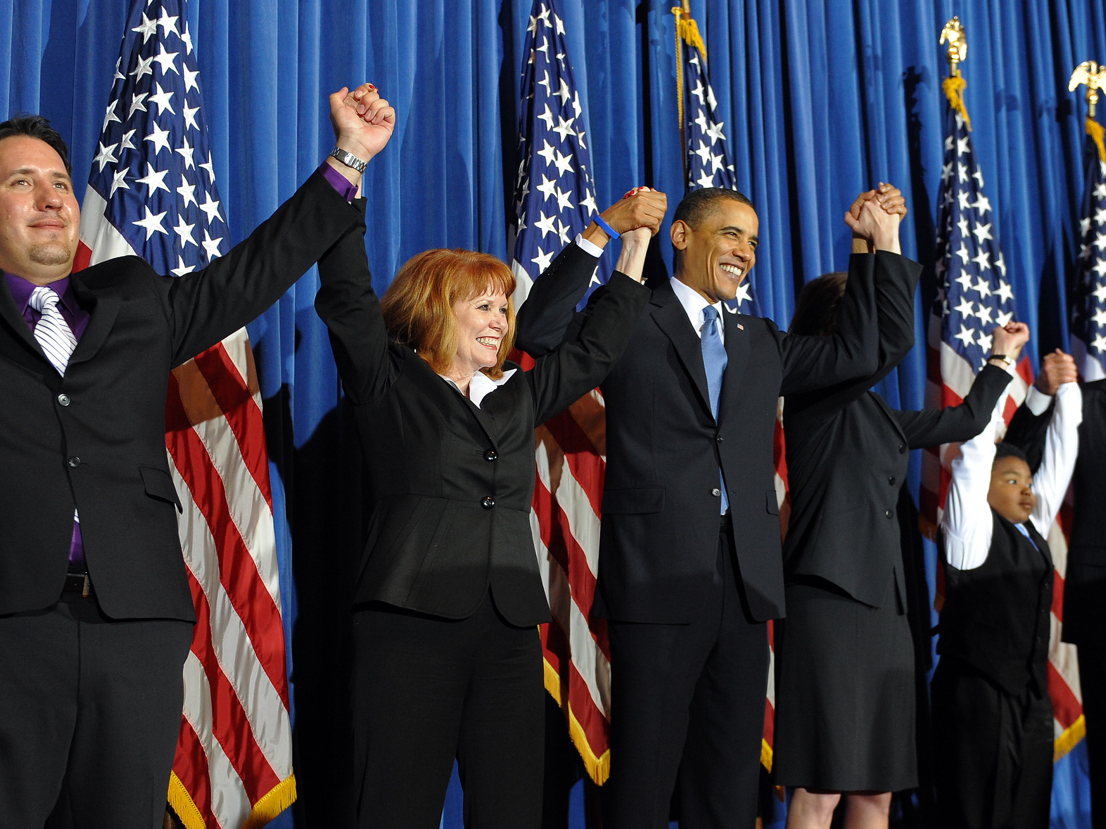 President Barack Obama celebrates with lawmakers after signing into law the Patient Protection and Affordable Care Act health insurance bill in March 2010. (AFP via Getty Images)