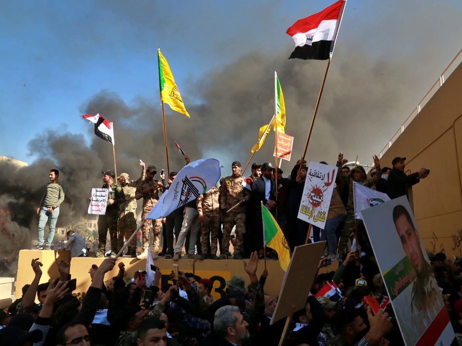 Protesters set fires in front of the U.S. Embassy compound in Baghdad on Tuesday. (Khalid Mohammed/AP)