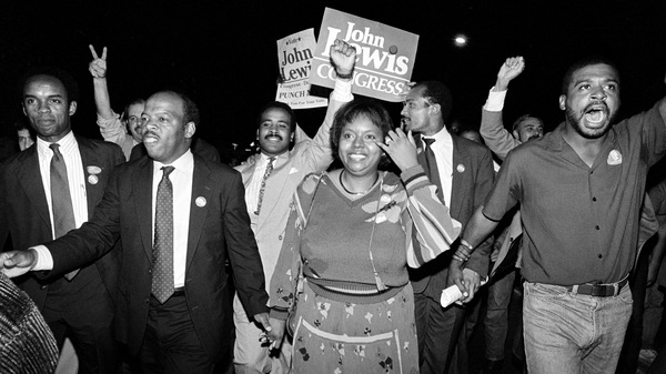 John Lewis and his wife, Lillian, lead supporters from his campaign headquarters to an Atlanta hotel for a victory party in 1986.