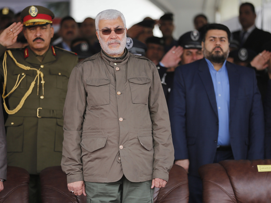 In this 2016 file photo, Abu Mahdi al-Muhandis, center, attends a ceremony marking Police Day in Baghdad, Iraq. Muhandis was killed in a drone strike early Friday. (Karim Kadim/AP)