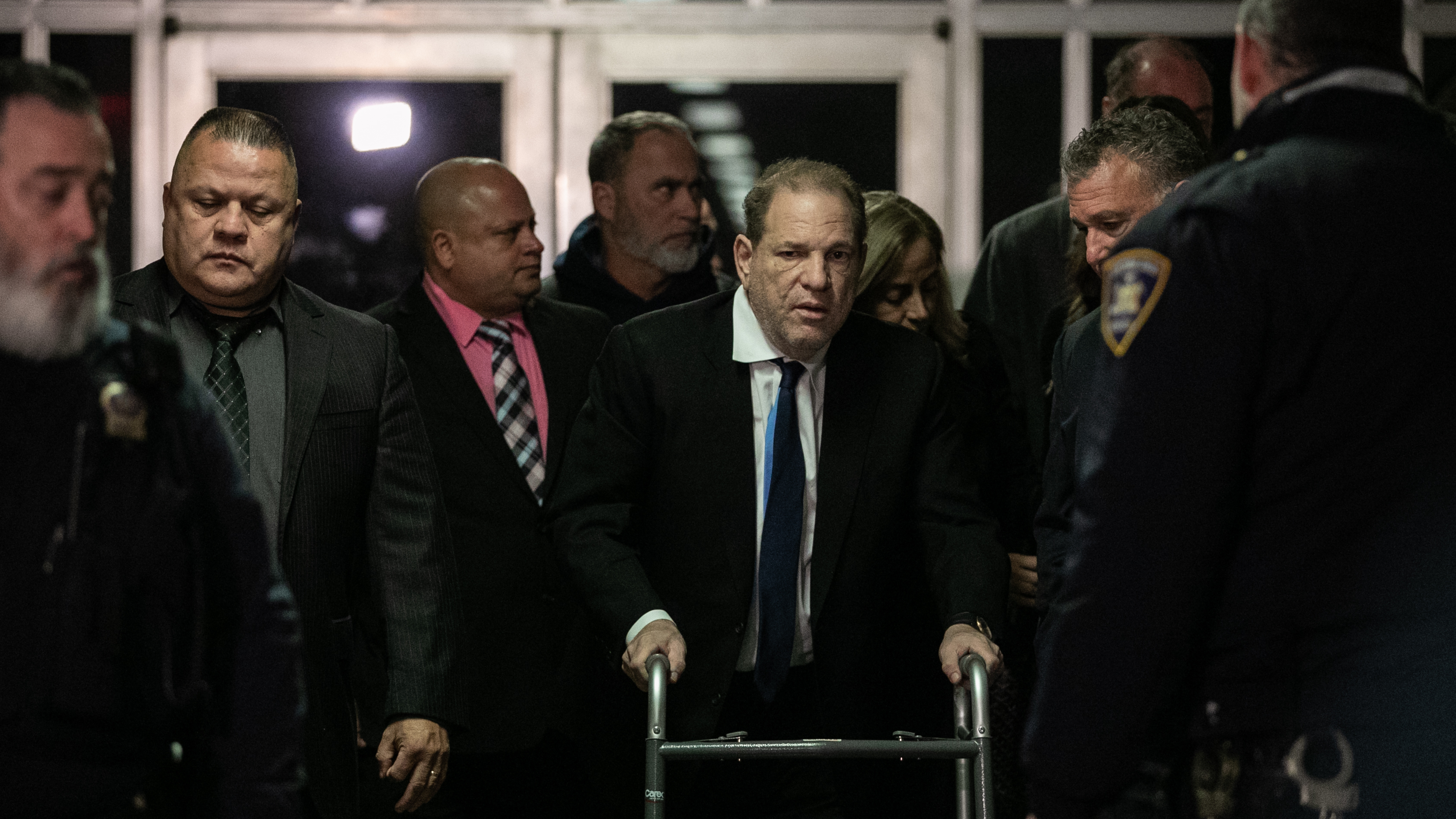 Harvey Weinstein (center) leaves a bail hearing last month in New York City. The former Hollywood megaproducer has been accused of sexual misconduct by dozens of women. He now faces five charges in New York City. (Getty Images)