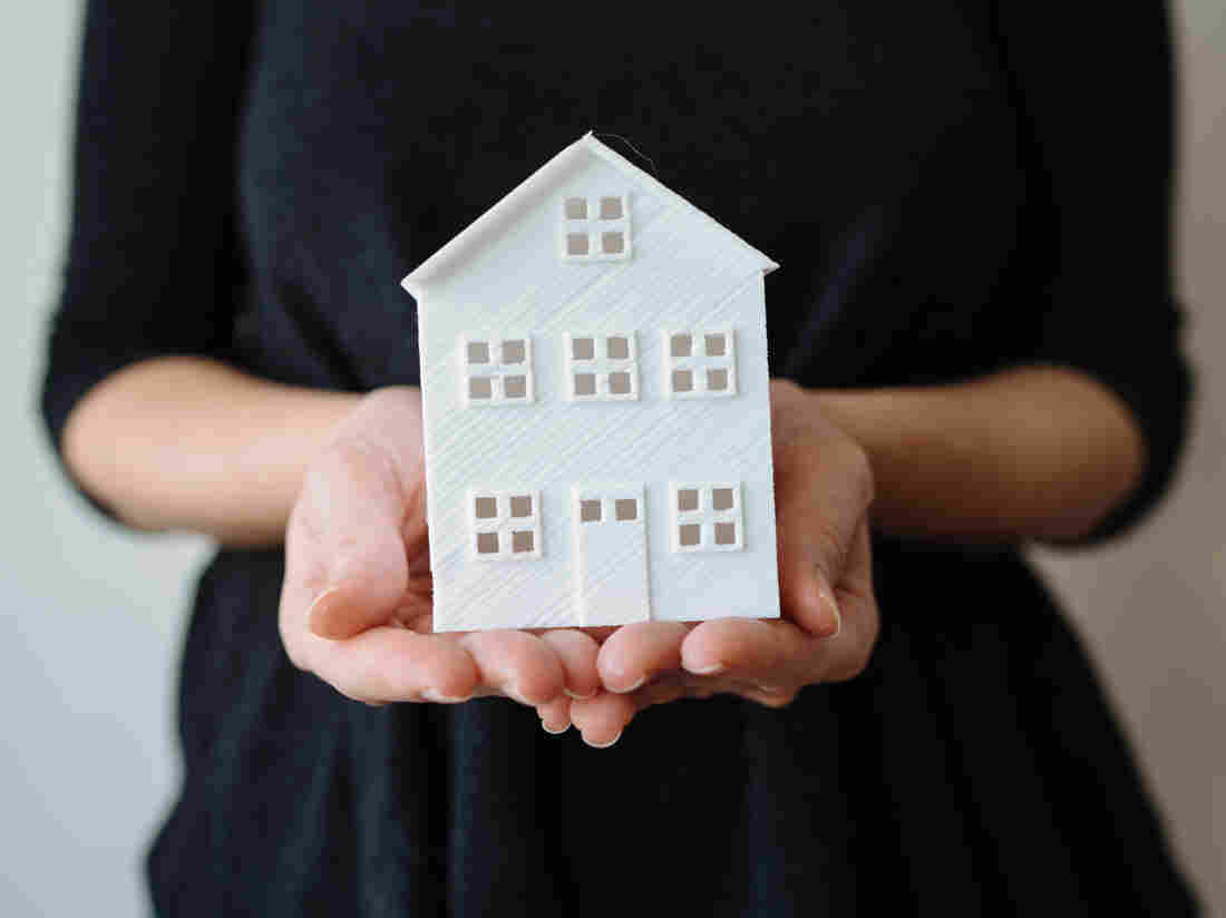 Model house in woman hand