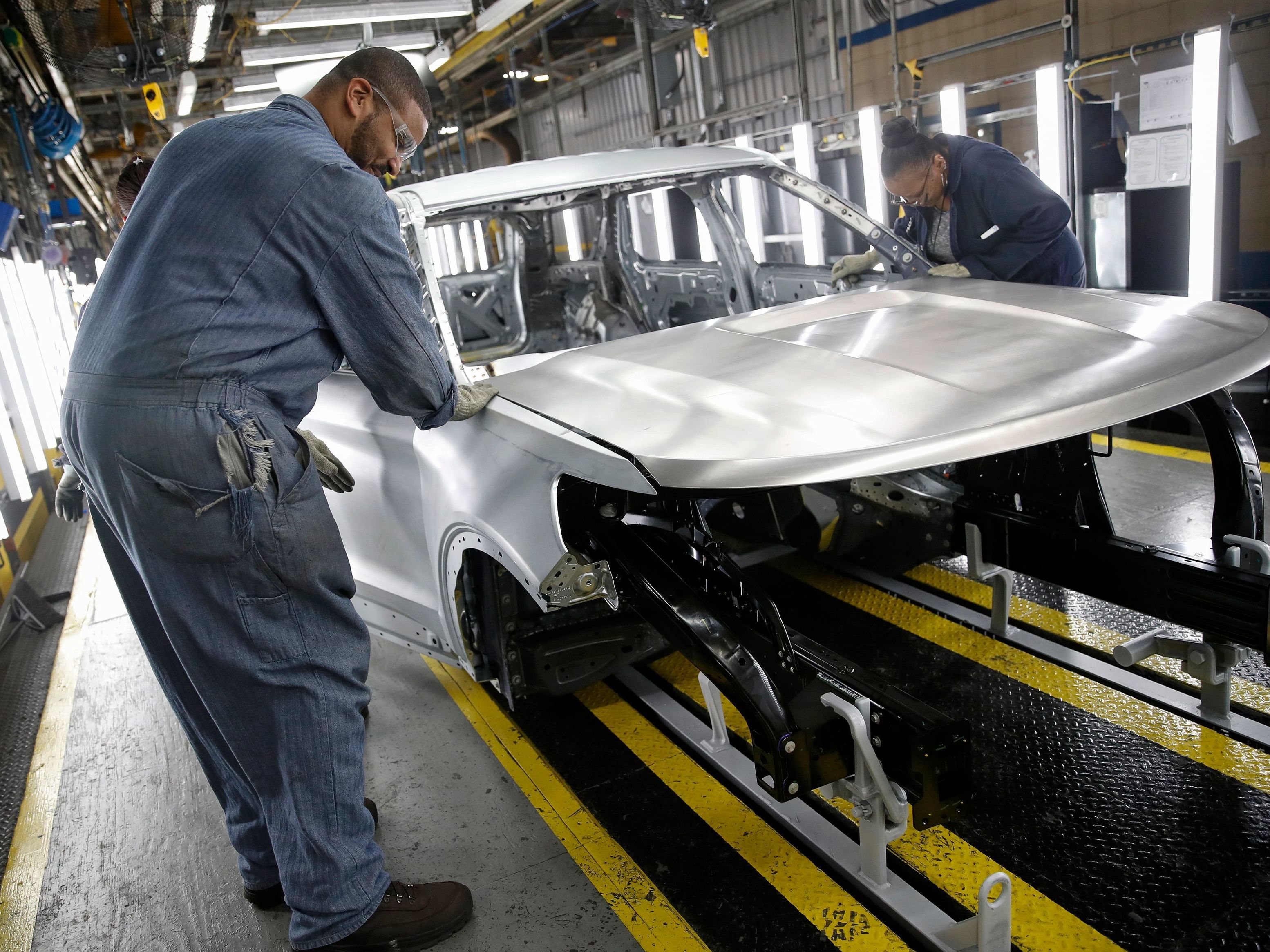 Workers assemble cars at Ford's newly renovated assembly plant in Chicago. Factories lost 12,000 jobs in December. The manufacturing sector has been hard hit by the trade war as well as slowing demand overseas. (AFP via Getty Images)
