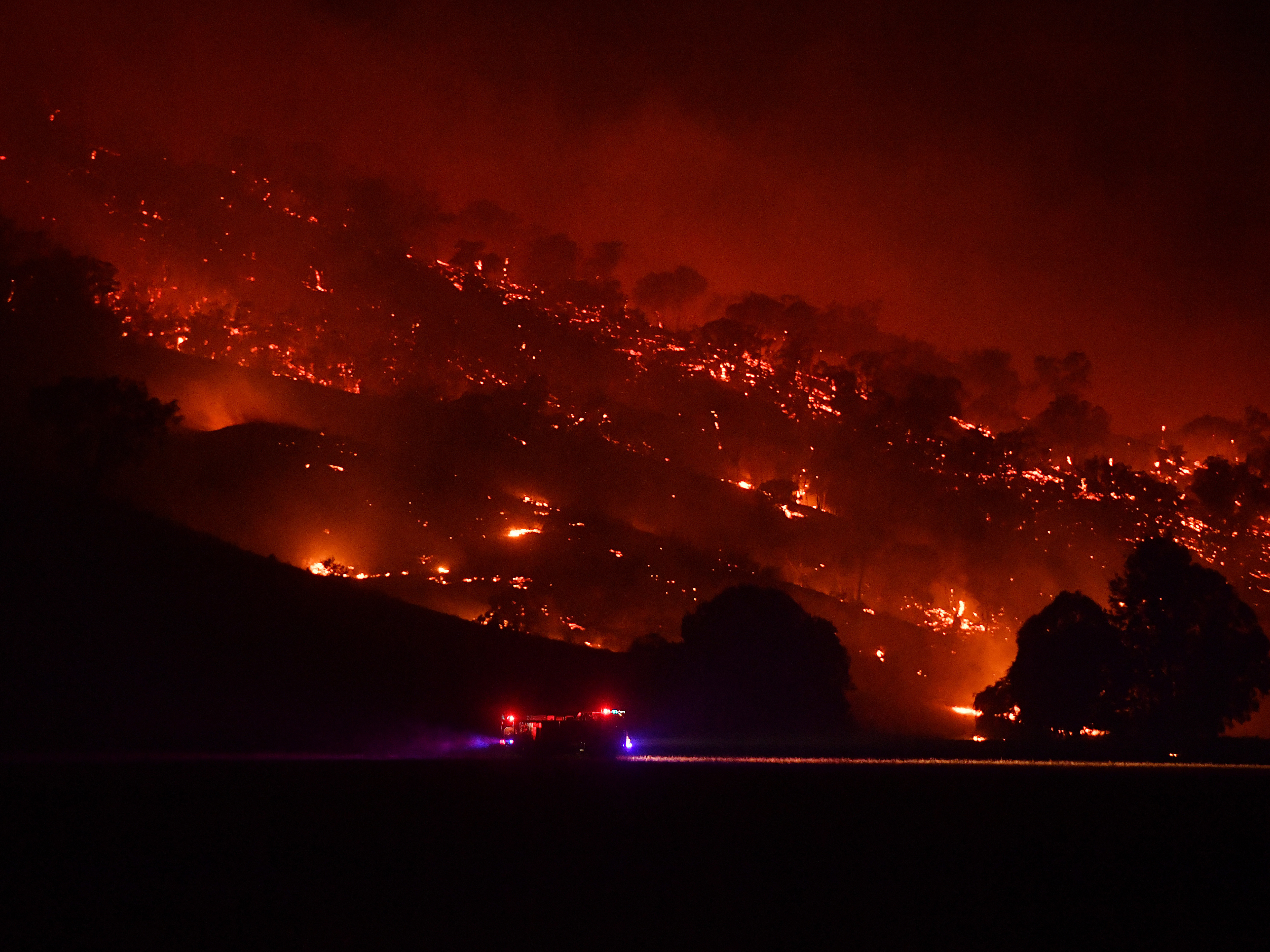 Firefighters conduct property protection patrols at the Dunn Road Fire on Friday in Mount Adrah, Australia. New South Wales is battling severe fire conditions, with high temperatures and strong winds forecast across the state. (Getty Images)