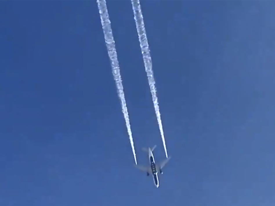 In this image from video, a Delta plane dumps fuel over Los Angeles before returning for an emergency landing on Tuesday. Fire officials say fuel fell onto an elementary school playground. (Matt Hartman/AP)