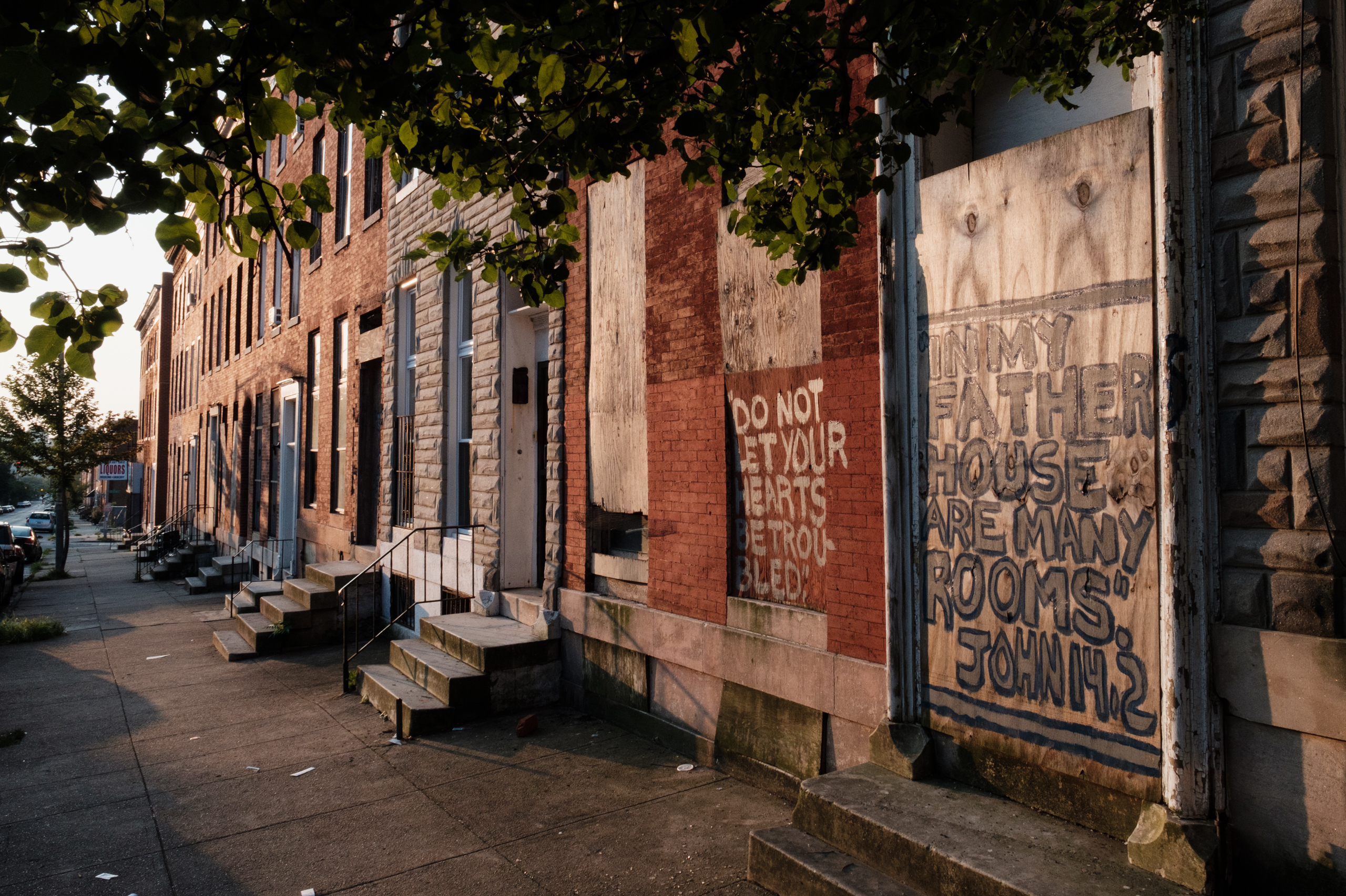 Vacant rowhouses line a portion of Franklin Square, a formerly redlined neighborhood in Baltimore. New research shows many communities subjected to discriminatory housing practices in the 1930s are hotter today. (Ian Morton for NPR)