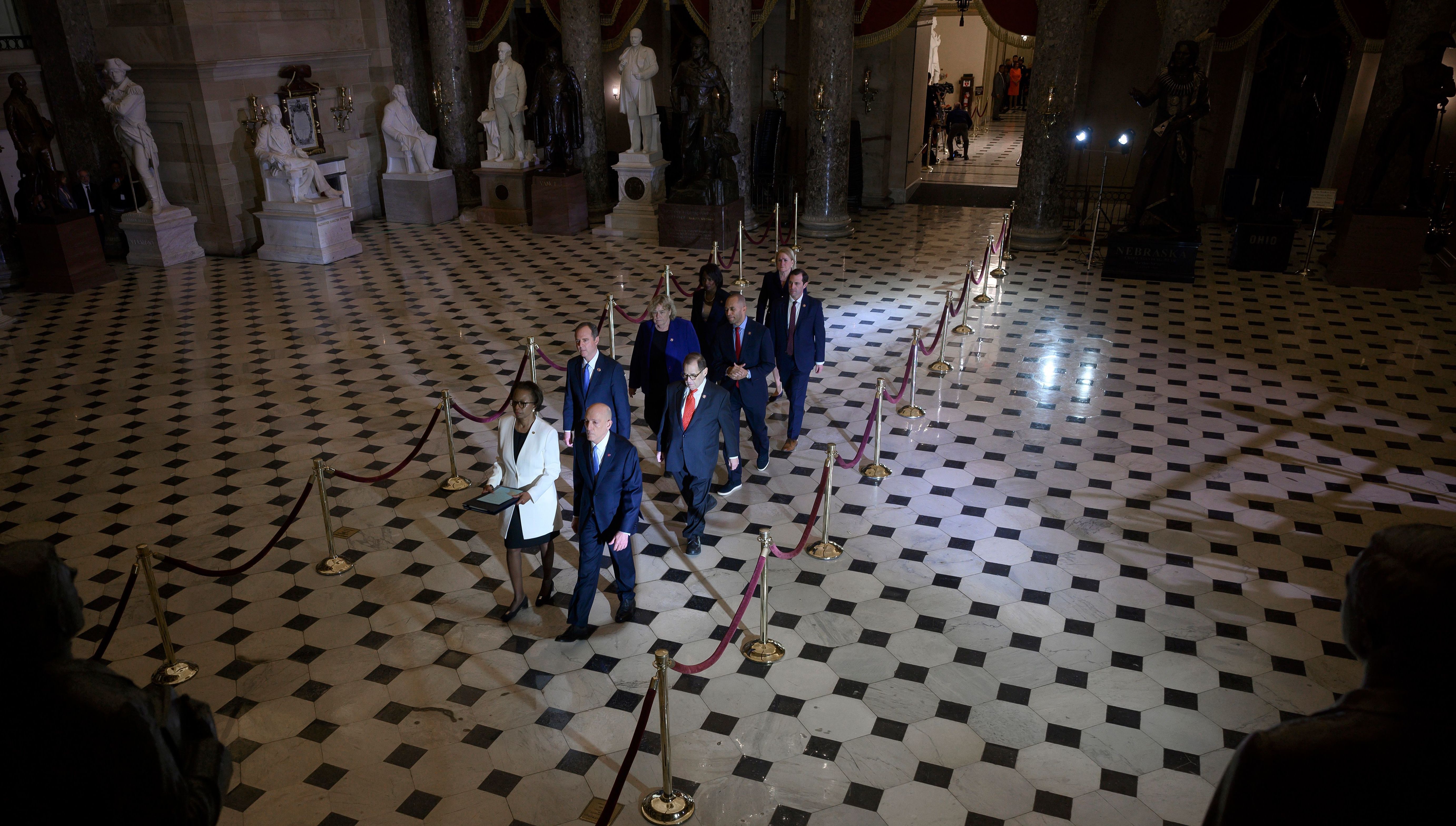 House managers walk to the Senate to deliver the articles of impeachment against President Trump on Capitol Hill on Wednesday. (AFP via Getty Images)