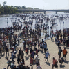 Migrant Caravan Crosses River into Mexico In Standoff With Security Forces