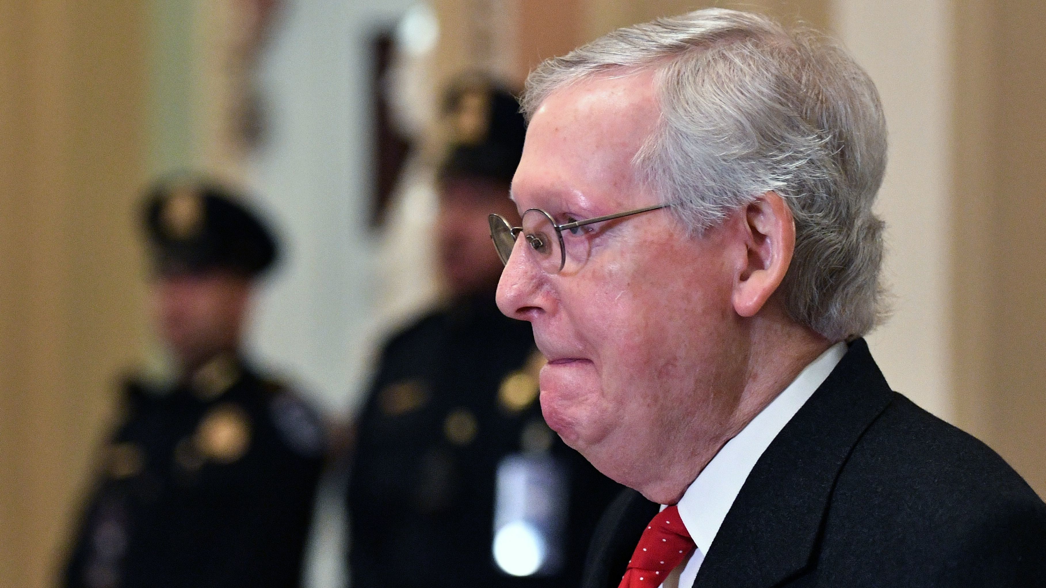 Republican Senate Majority Leader Mitch McConnell arrives for the start of President Trump's impeachment trial Tuesday. (AFP via Getty Images)