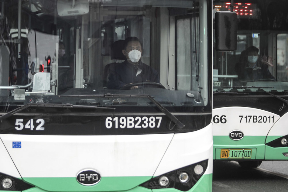 A bus driver wears a mask on Jan. 22 in Wuhan, China. Public transportation is being suspended as of Thursday morning because of concerns about the spreading coronavirus. (Stringer/Getty Images)