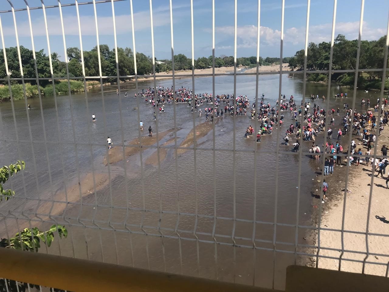 Honduran migrants cross the Suchiate River from Guatemala into Mexico, where they are met by National Guard troops, on Monday. Mexico has detained and deported many of the migrants in the caravan. (James Fredrick for NPR)