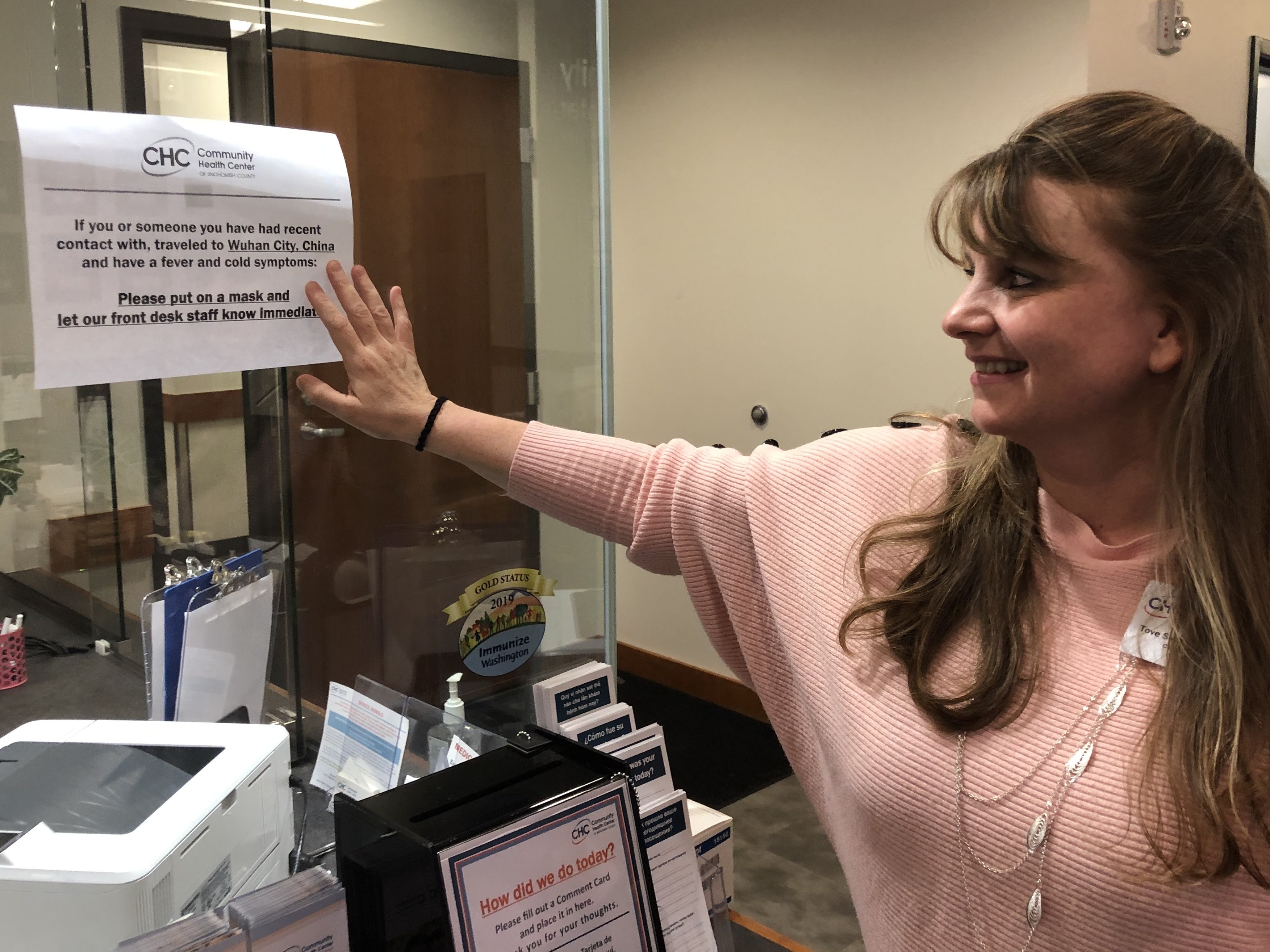 Tove Skaftun, the chief nursing officer for the Community Health Center of Snohomish County, points out a sign warning people who could have been exposed to the new coronavirus from China to identify themselves. (Will Stone for NPR)