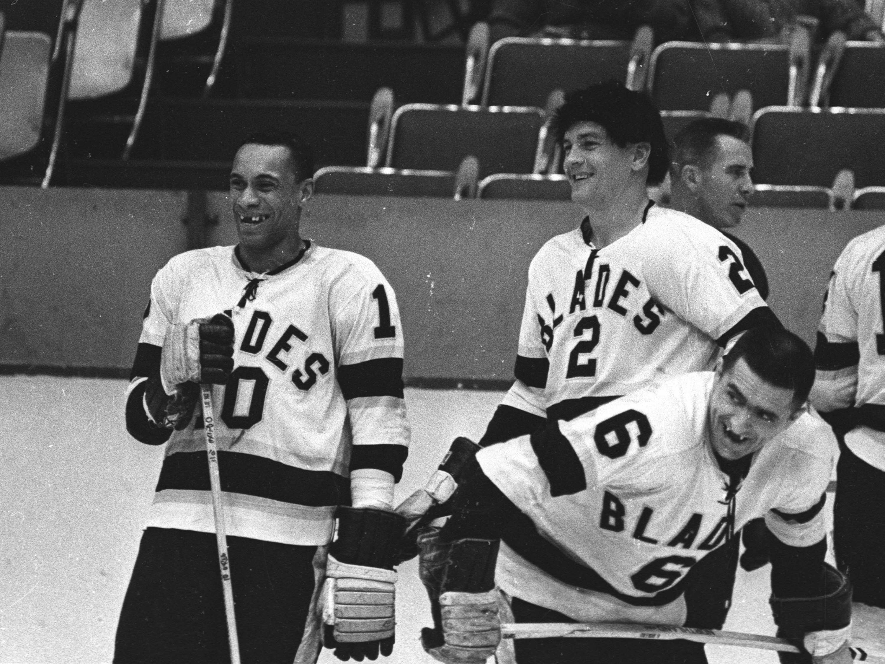 Willie O'Ree (left) and Howie Young (center) of the Los Angeles Blades talk during warm ups before their game at the Los Angeles Sports Arena during the 1963-64 season in Los Angeles, Calif. O'Ree became the first black player in the National Hockey League when he joined the Boston Bruins in 1958. (Getty Images)