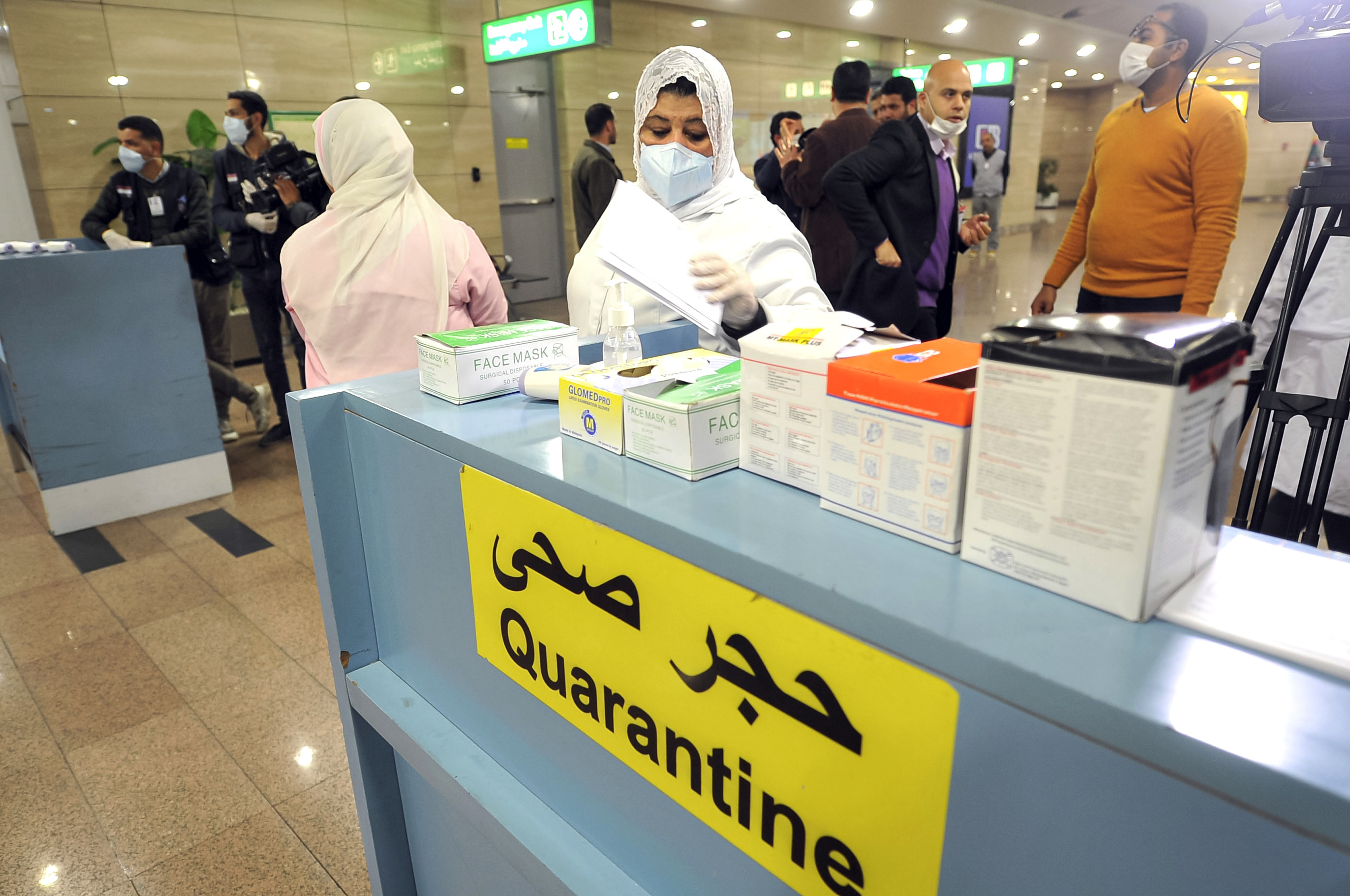 Employees of the Egyptian Quarantine Authority prepare to scan the body temperature of incoming travelers at Cairo International Airport. (AFP via Getty Images)