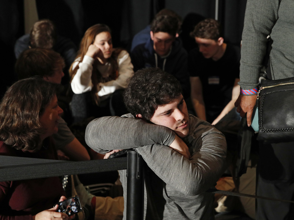 People wait for results at a caucus night campaign rally for former Vice President Joe Biden on Monday in Des Moines, Iowa. (John Locher/AP)