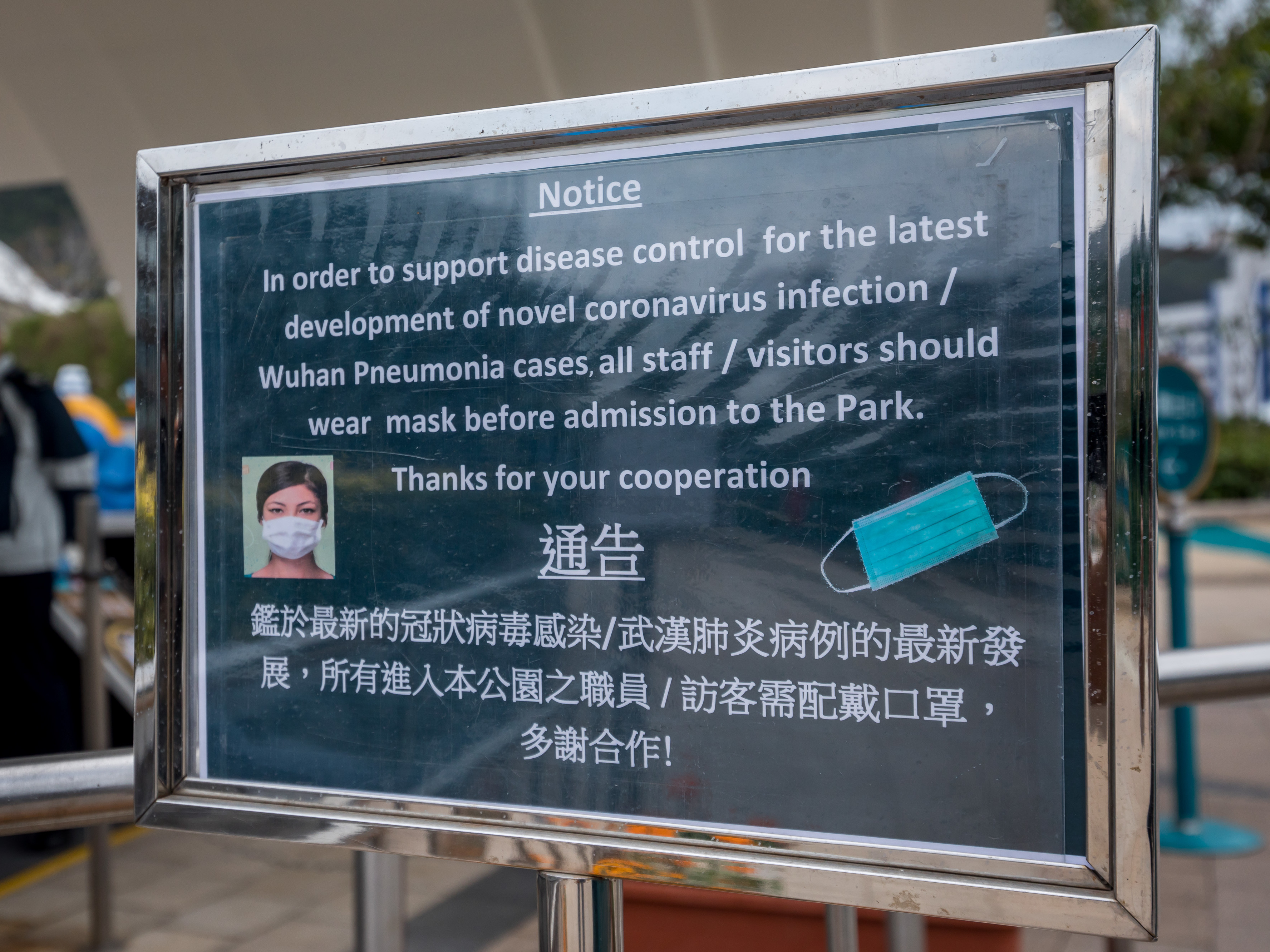 A notice advising all staff and visitors to wear protective masks stands outside the closed Ocean Park in Hong Kong, on Monday. (Bloomberg via Getty Images)