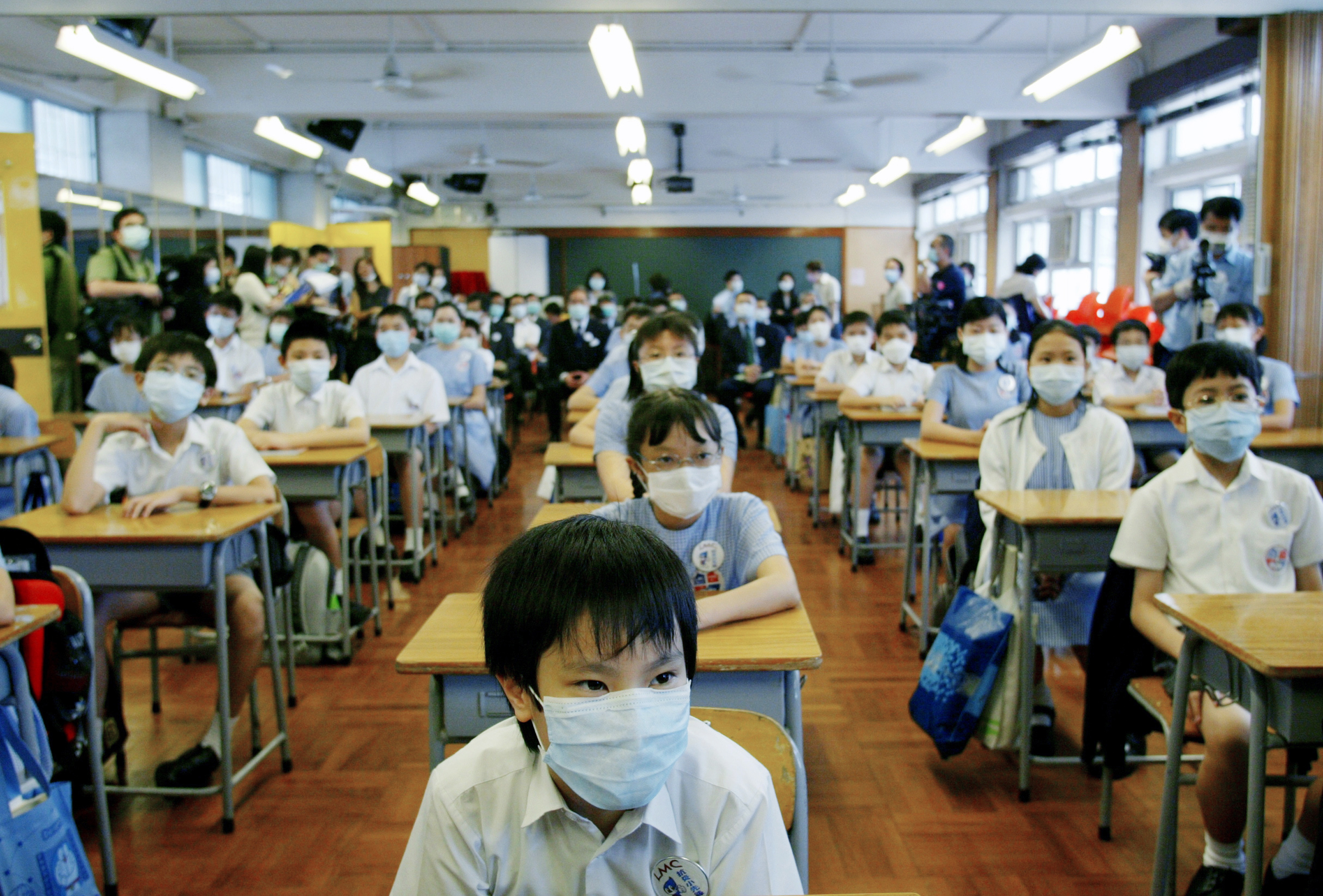 School was suspended for six weeks in Hong Kong as part of the strategy to keep SARS from spreading. On May 12, 2003, primary school children returned to class amid signs that the outbreak was coming under control. (Reuters)