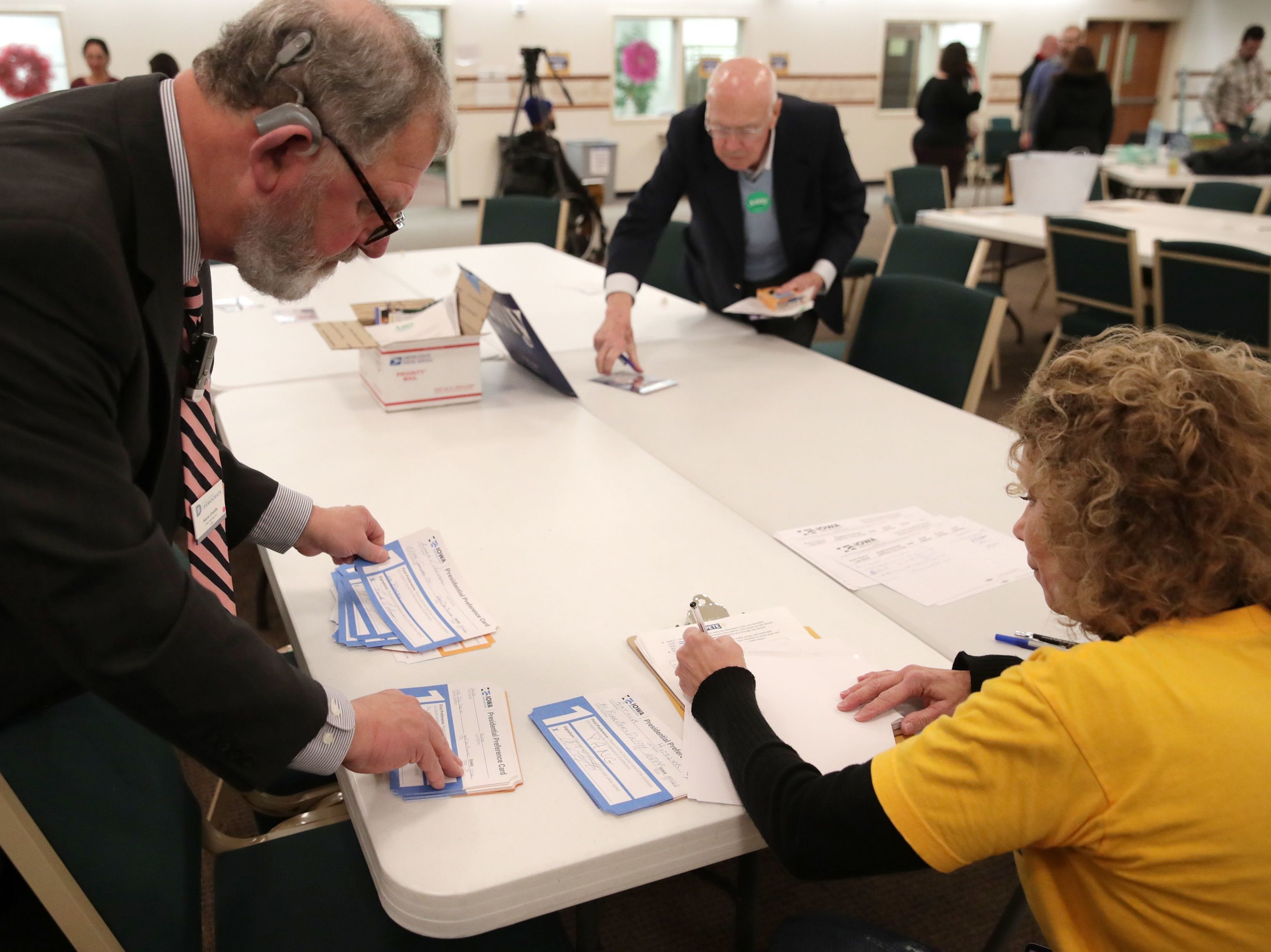 Presidential preference cards are counted at a caucus at West Des Moines Christian Church in Iowa on Monday. Problems with a smartphone app designed to report the caucus results ended up delaying an official count. (Reuters)