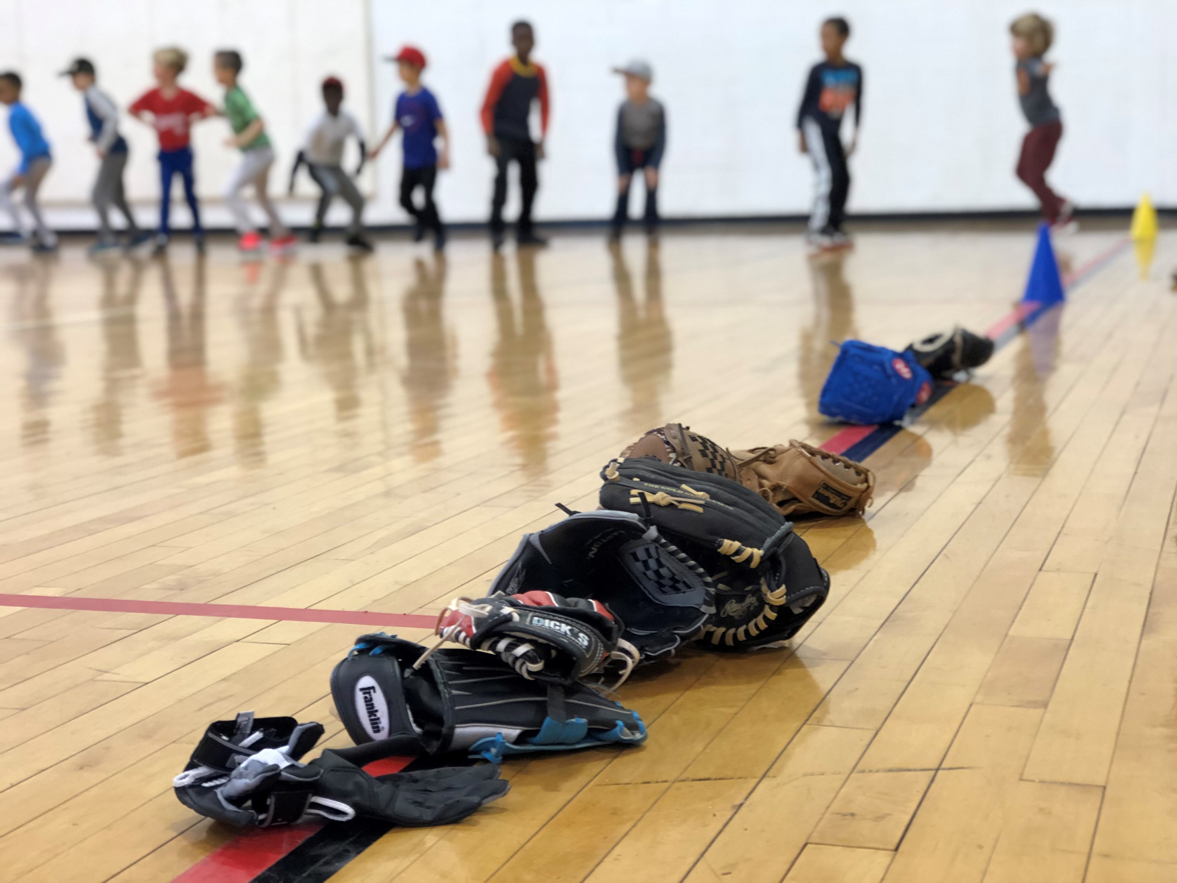 Kids do calisthenics before starting a baseball clinic in Washington, D.C. (WAMU)