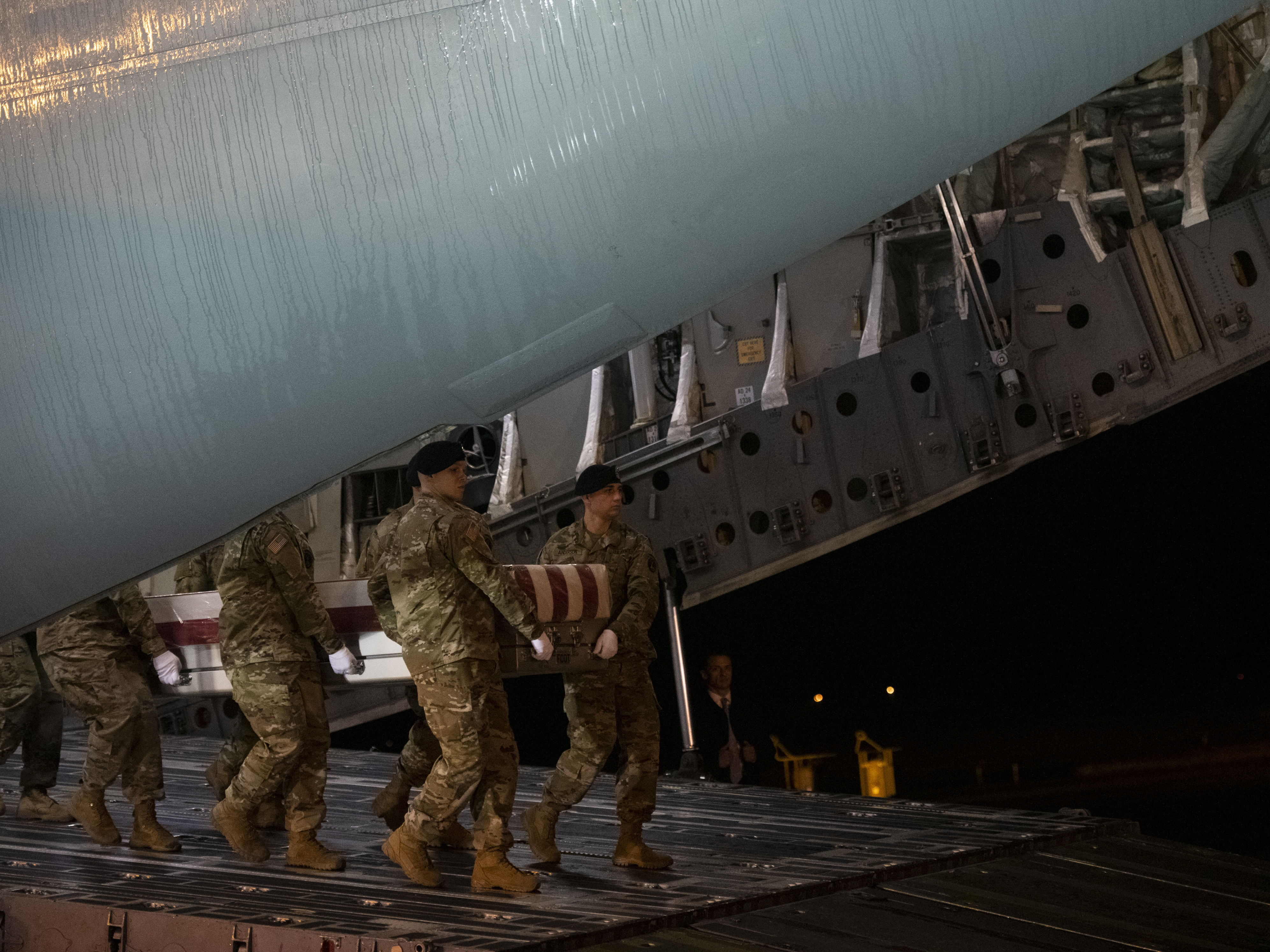 Military personnel carry a transfer case for fallen service member, U.S. Army Sgt. 1st Class Javier J. Gutierrez, 28, during a dignified transfer ceremony at Dover Air Force Base. (Getty Images)