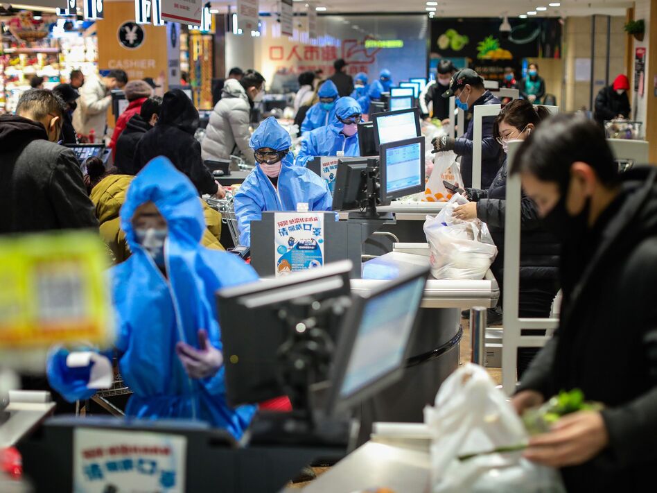 People wearing protective masks shopping at a supermarket in Shenyang in China's northeastern Liaoning province, on Monday. (AFP via Getty Images)
