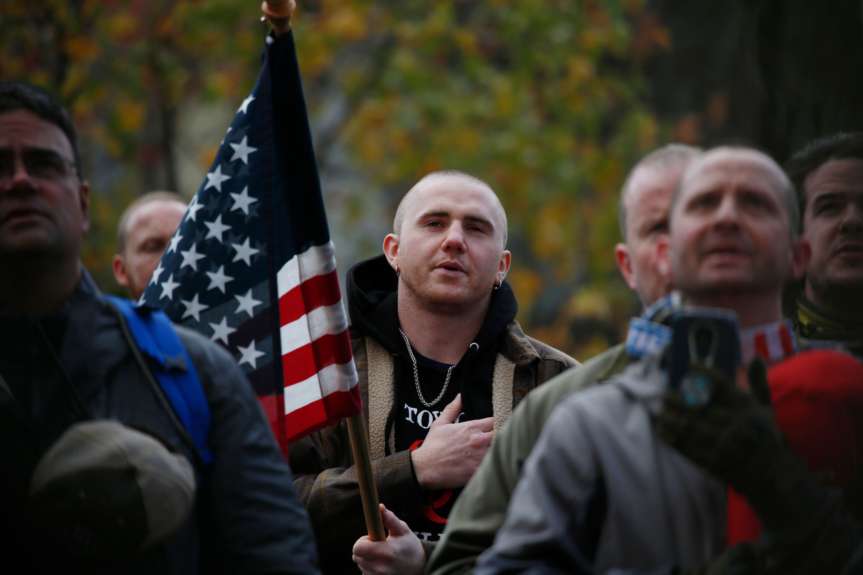 Attendees recite the Pledge of Allegiance during the United Against Hate rally by the Washington Three Percent in Seattle last month. (Jim Urquhart for NPR)