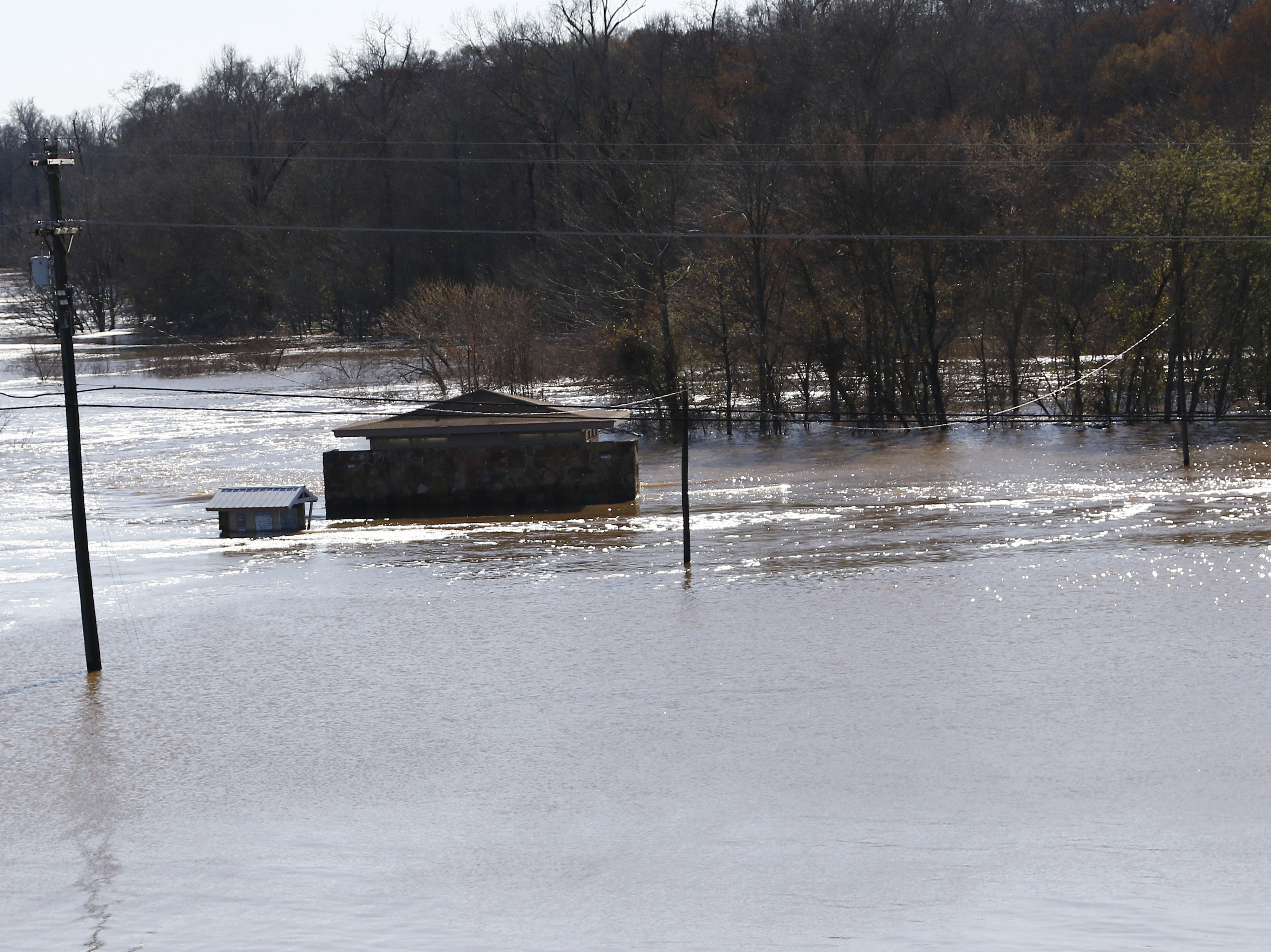The restrooms on the Madison County side of the Ross Barnett Reservoir Spillway Park are about the only structure still visible as floodwaters have covered both sides of the popular fishing and boat landing in central Mississippi.