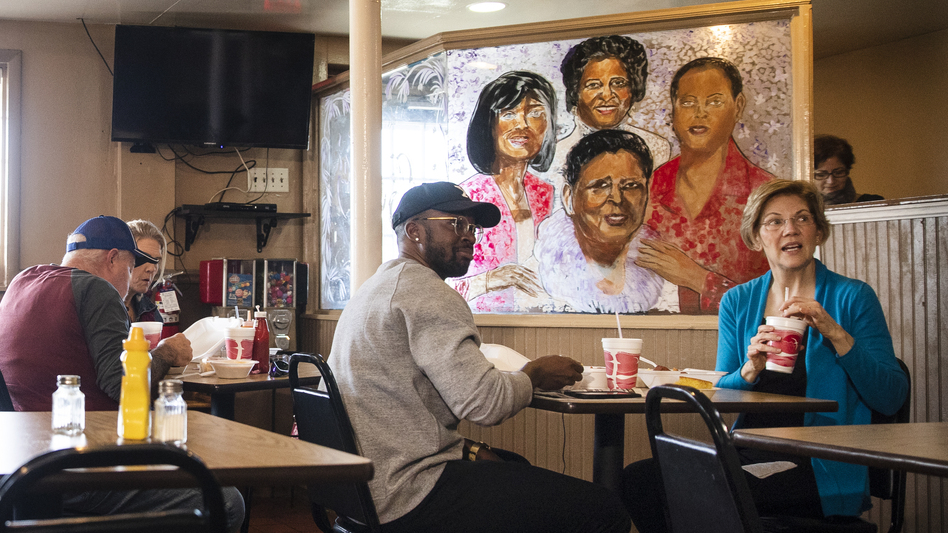 Democratic presidential candidate Sen. Elizabeth Warren, D-Mass., eats lunch with musician Benny Starr at Bertha's Kitchen on Friday in North Charleston, S.C. (Matt Rourke/AP)
