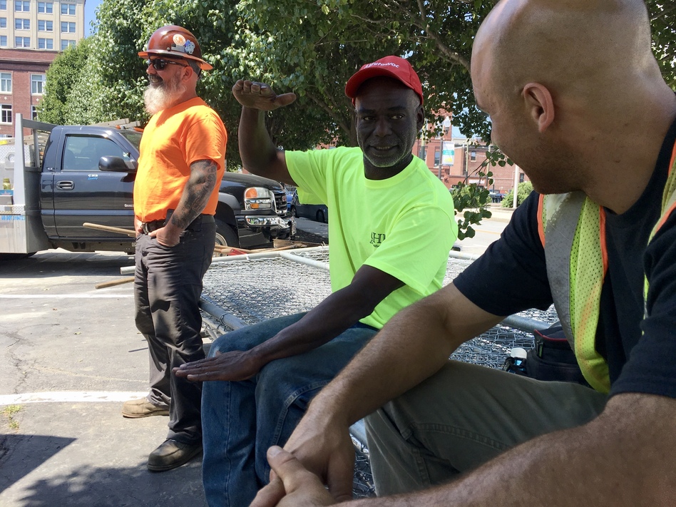 Calvin Brandford (center) is a certified minority contractor who has run an excavation business north of Boston for almost 30 years. Brandford said getting state-funded work as a subcontractor is very hard and often comes with a serious drawback: not getting paid for 60 to 90 days. (Chris Burrell/WGBH)