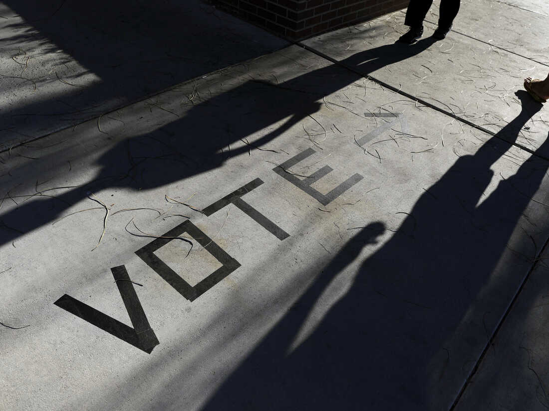 In this Nov. 6, 2018, photo, voters head to the polls at the Enterprise Library in Las Vegas. Nevada's Democratic Party announced new paper-based balloting for its early vote as it scrambles to reconfigure plans and avoid tech problems and reporting delays that mired Iowa's first-in-the-nation caucuses.