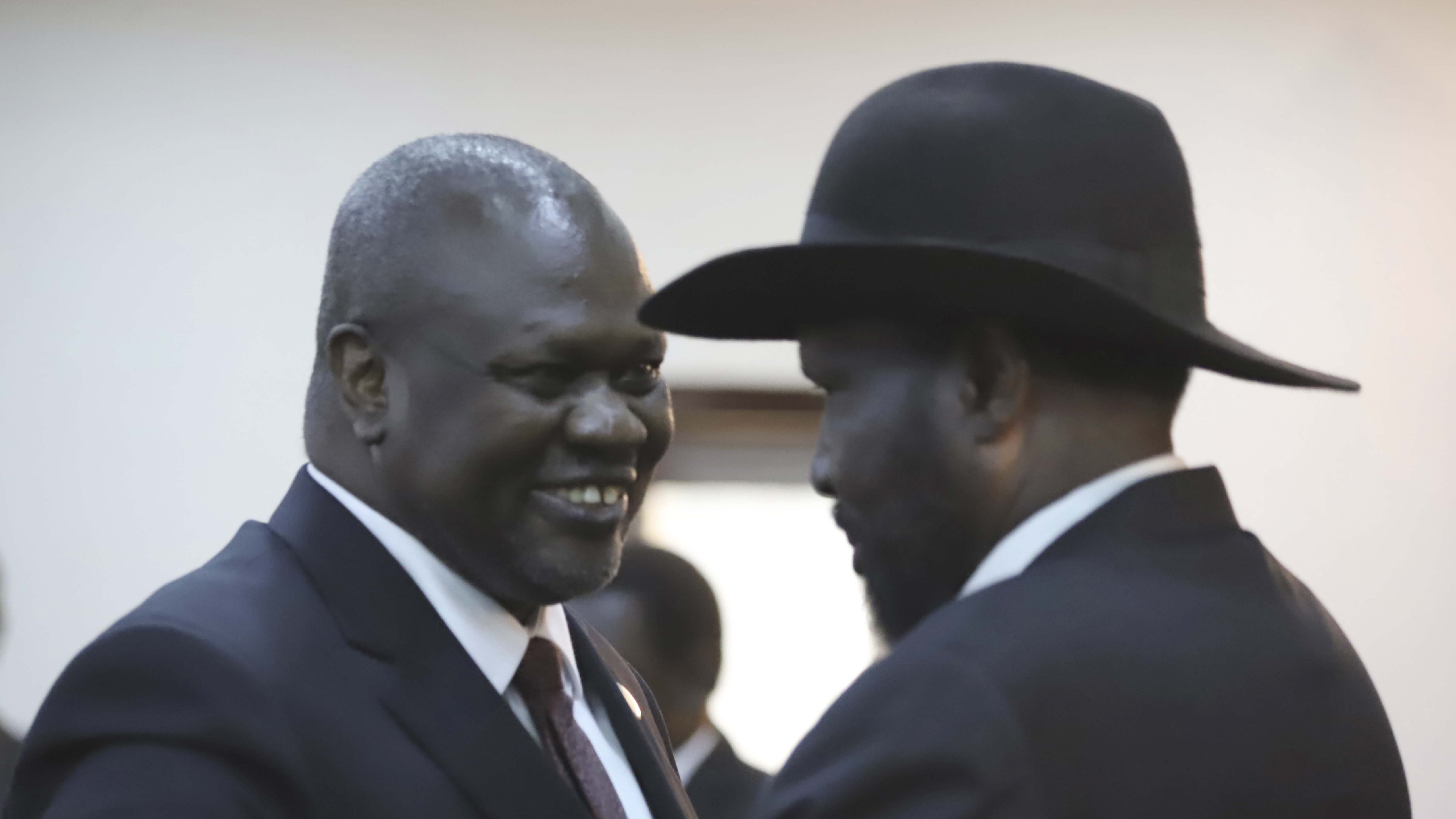 Riek Machar (left) shares a smile with South Sudan