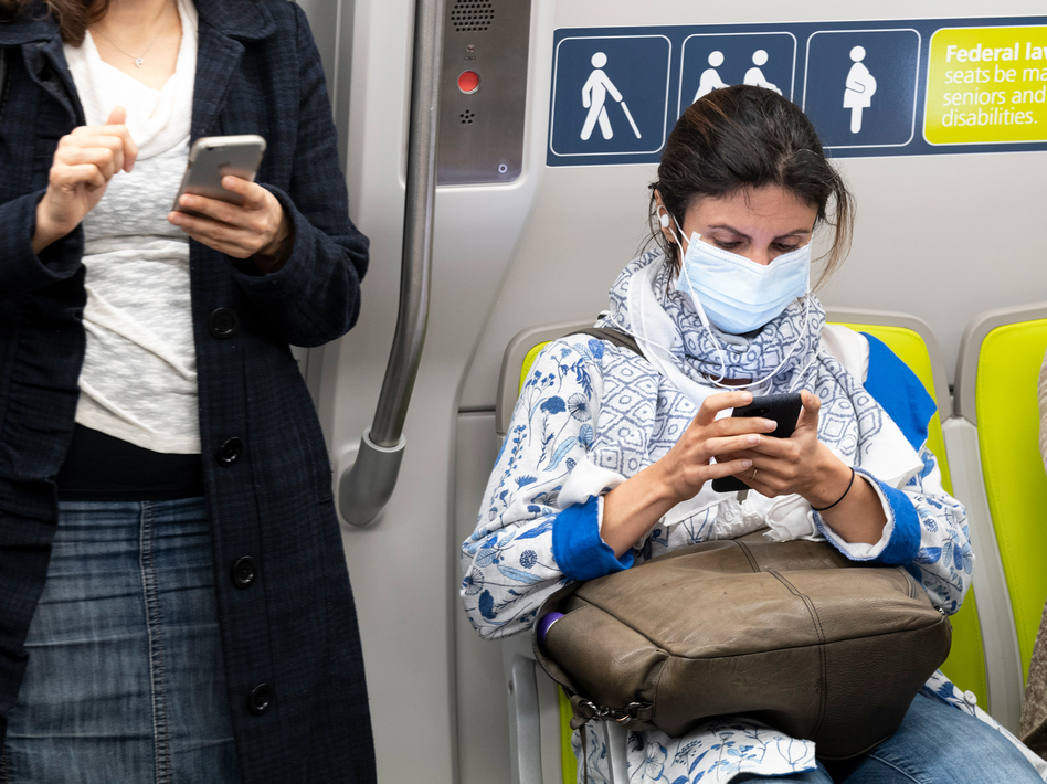 Health officials have identified what could be the first U.S. case of the novel coronavirus spreading within the general population. But a hospital says the diagnosis was delayed for days. Here, a passenger wears a face mask on a train in San Francisco on Wednesday. (David Paul Morris/Bloomberg via Getty Images)