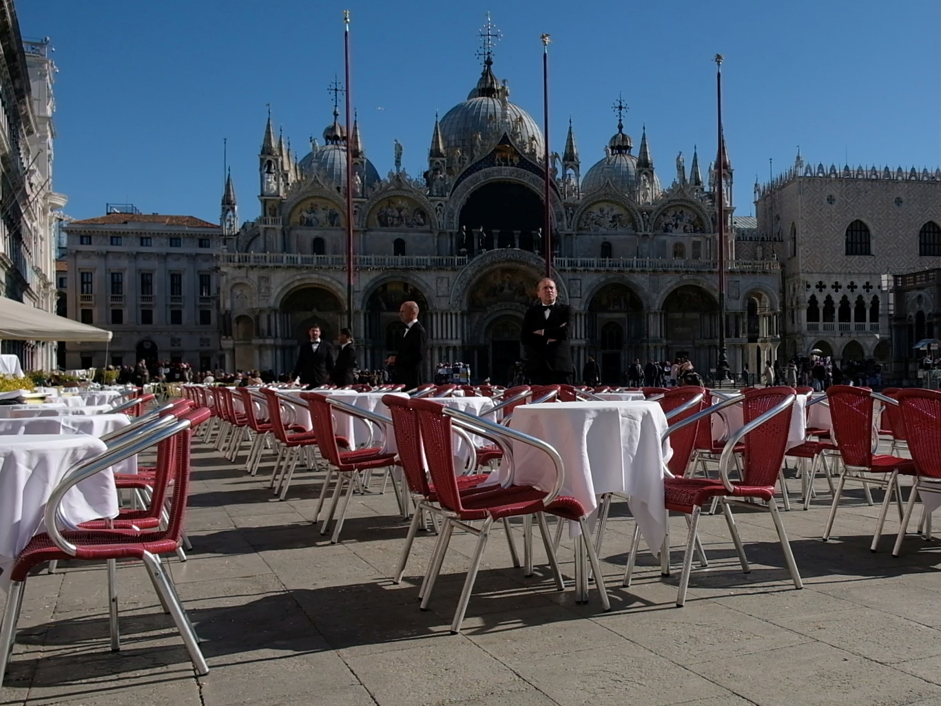 Waiters stand by an empty restaurant in Venice's St. Mark's Square, which would normally be full of tourists, as a coronavirus outbreak grows in Italy. (Reuters)