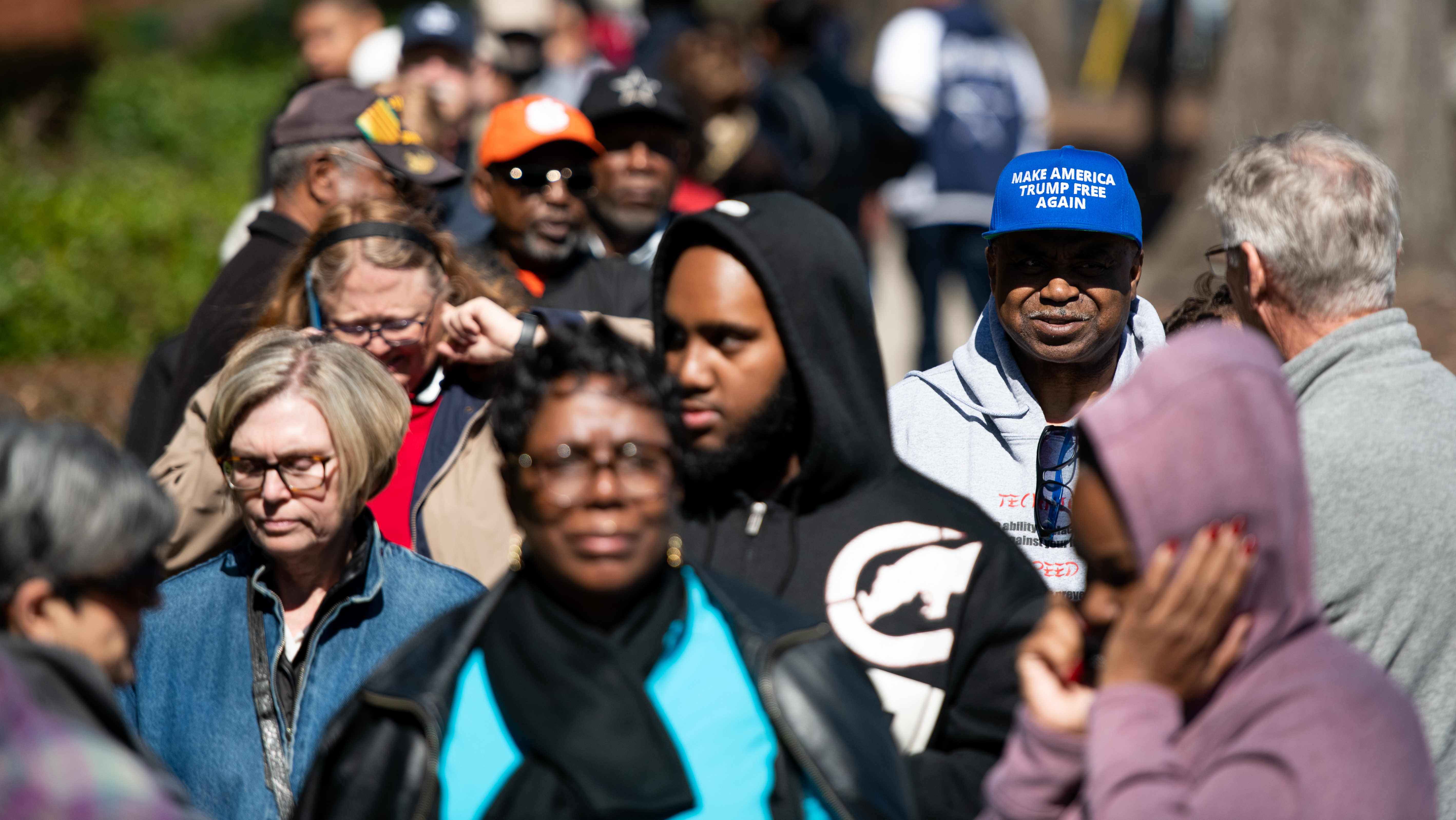 Al Hightower (in blue hat), a Joe Biden supporter, stands in line for early voting for the Democratic presidential primary at the Richland County Election Commission February 27, 2020 in Columbia, S.C.