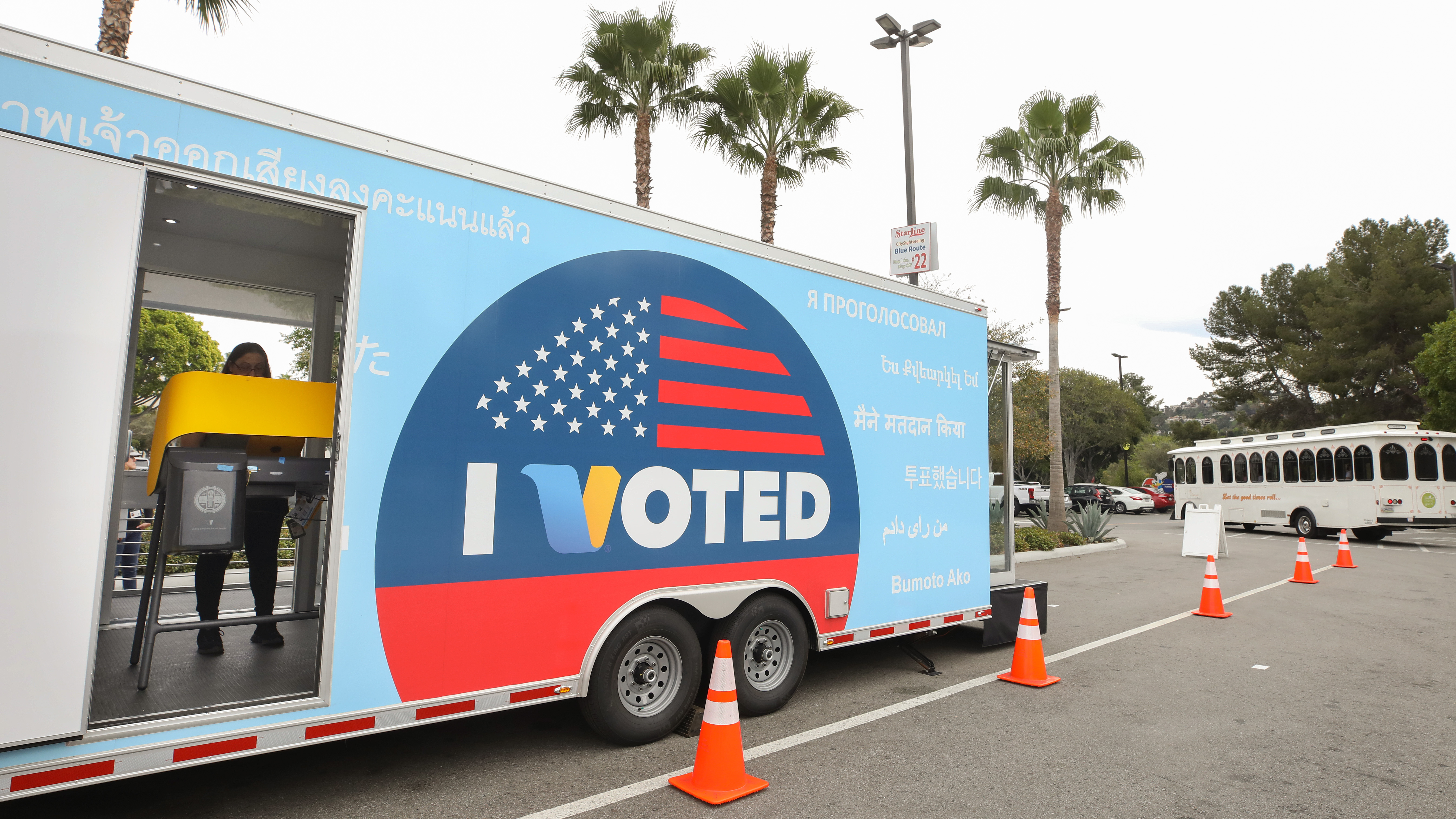 A voter prepares her ballot during early voting for the California presidential primary election at a new LA County &quot;Mobile Vote Center&quot; outside Universal Studios Hollywood on Thursday. Large numbers of Californians vote early and by mail, which can slow election night vote counting. (Getty Images)