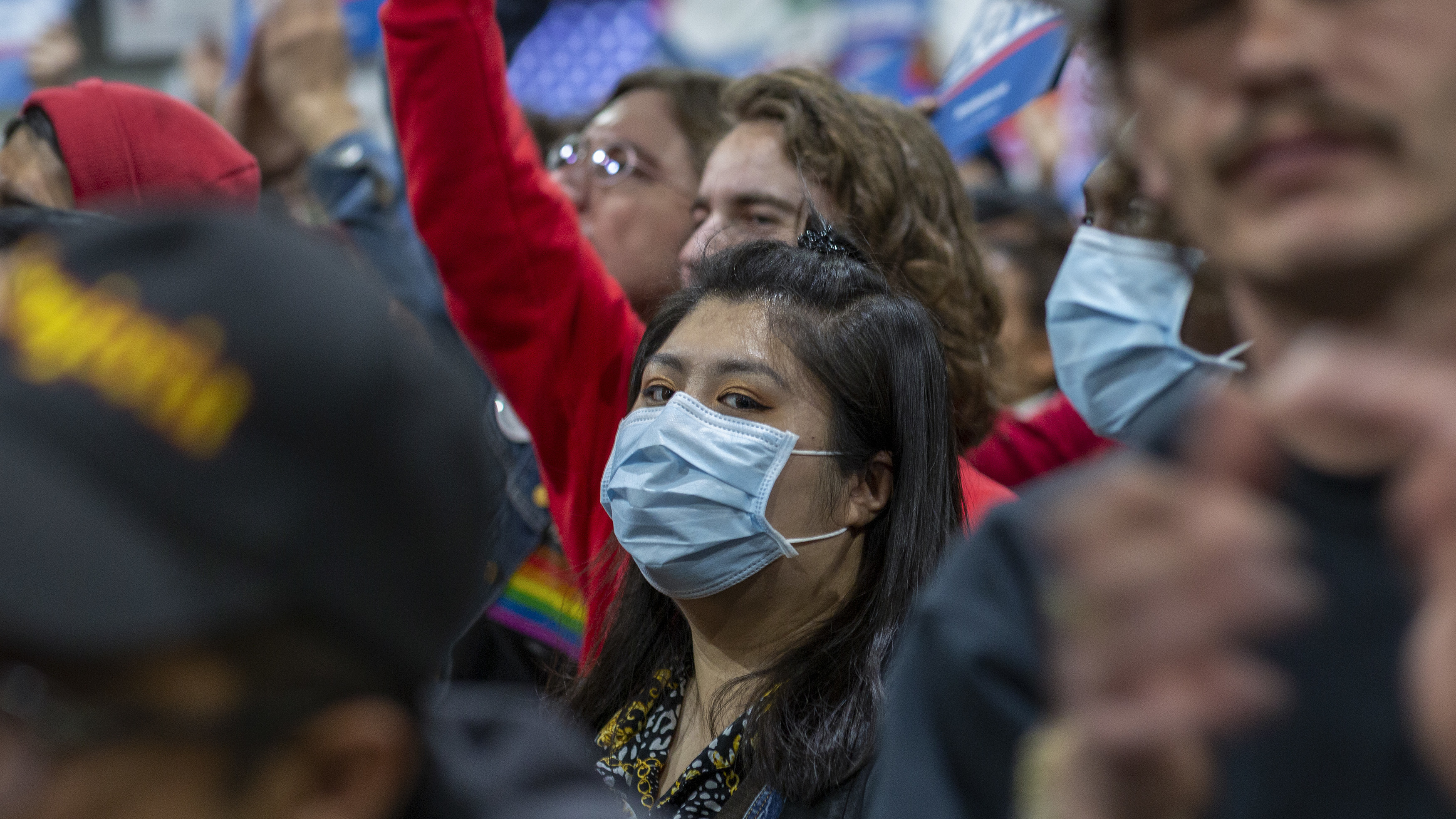 A woman in California wears a medical mask during a political campaign rally. A second person has died from COVID-19 in the U.S., officials in Washington state say.