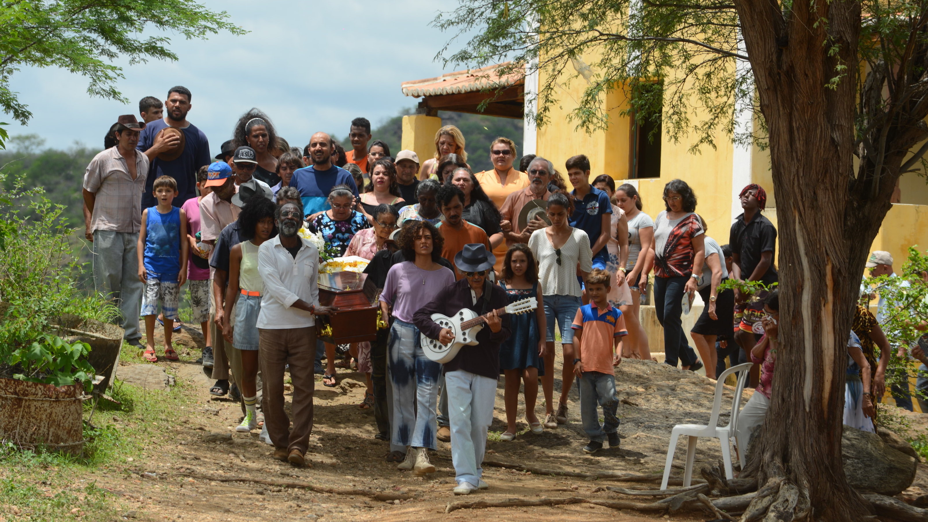 Mourners gather for a heartfelt burial ceremony in the Brazilian film <em>Bacurau</em>. (Kino Lorber)