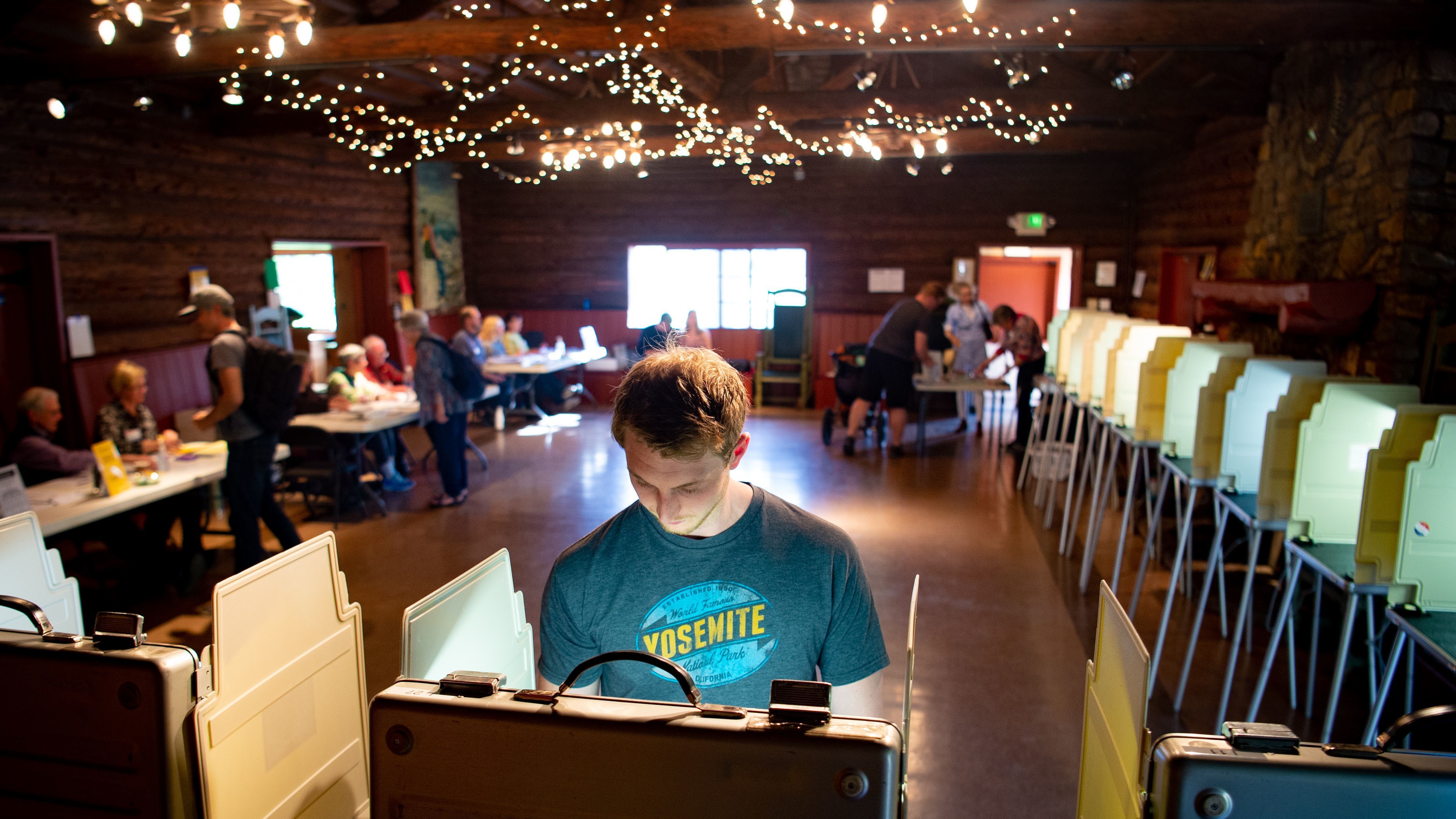 Voters fill out their ballots for the presidential primary in a log cabin run by the American Legion in San Anselmo, Calif., on Super Tuesday, March 3, 2020. While no significant foreign interference was detected, election and law enforcement officials are closely monitoring this year