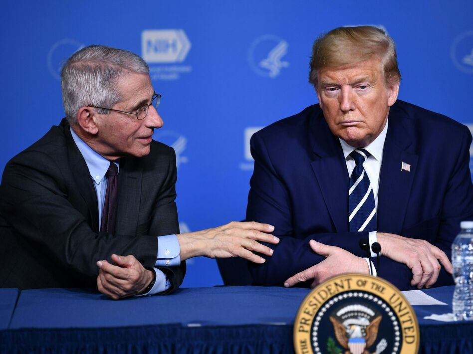 President Trump listens to Anthony Fauci, director of the NIH National Institute of Allergy and Infectious Diseases, after a tour earlier this week. (Brendan Smialowski/AFP via Getty Images)