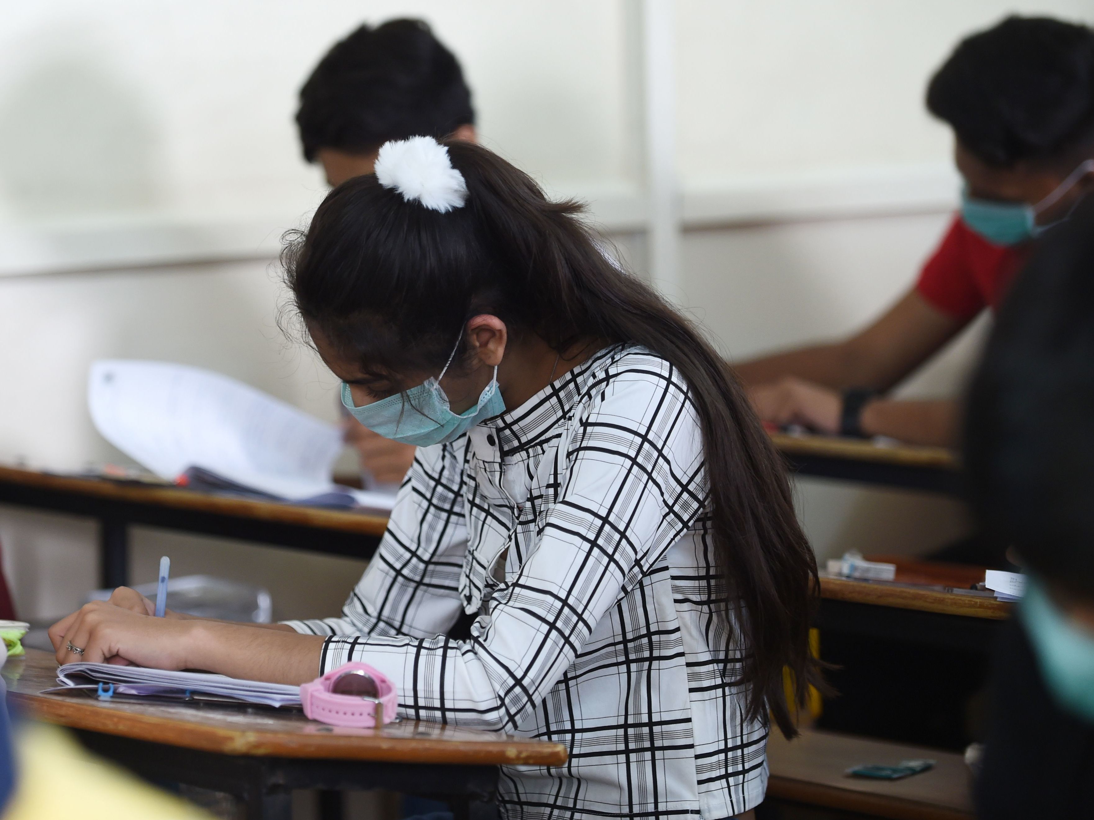 Students sit for an exam in Ahmedabad, India, on Thursday. In the nation's capital, New Delhi, all primary schools have been ordered closed until March 31 because of coronavirus concerns. (AFP via Getty Images)