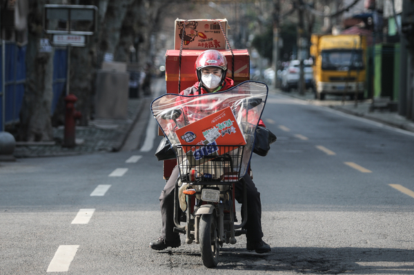 A courier with a scooter full of packages.