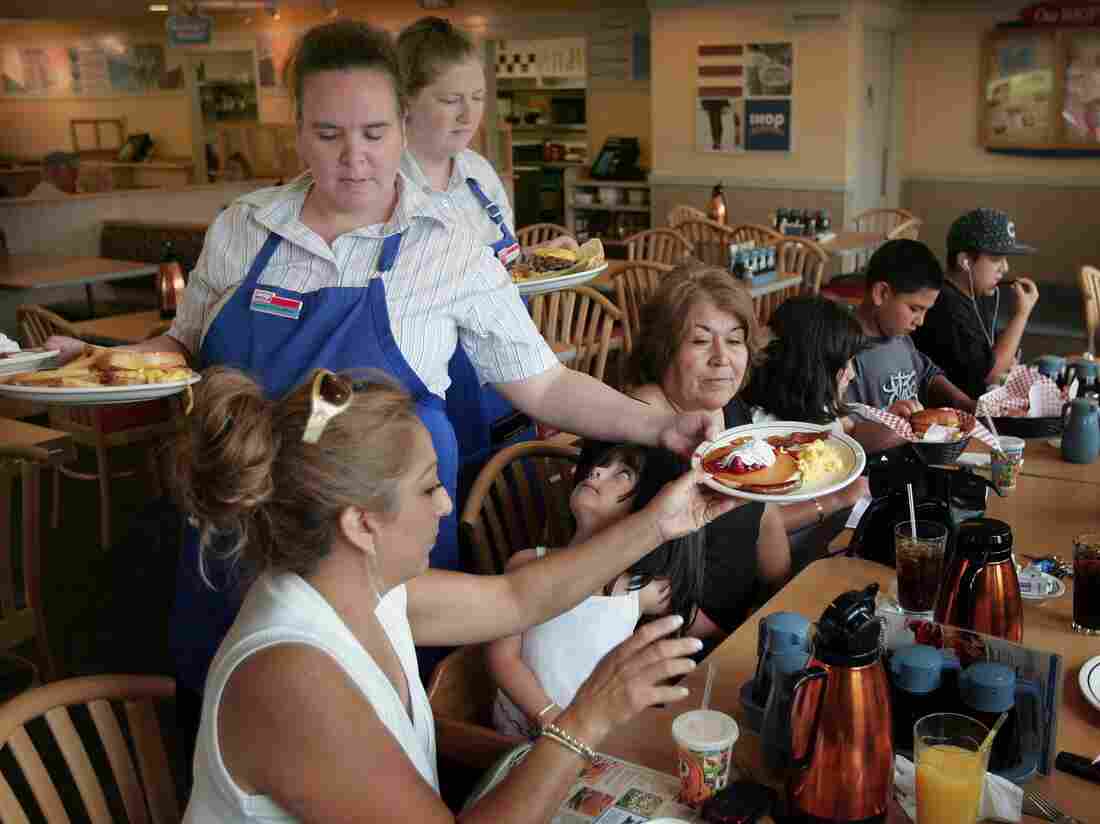 ELGIN, IL - JULY 16: Waitresses Gretchen Boren (L) and Michelle Enright wait on customers at an IHOP restaurant July 16, 2007 in Elgin, Illinois. (Photo by Scott Olson/Getty Images)