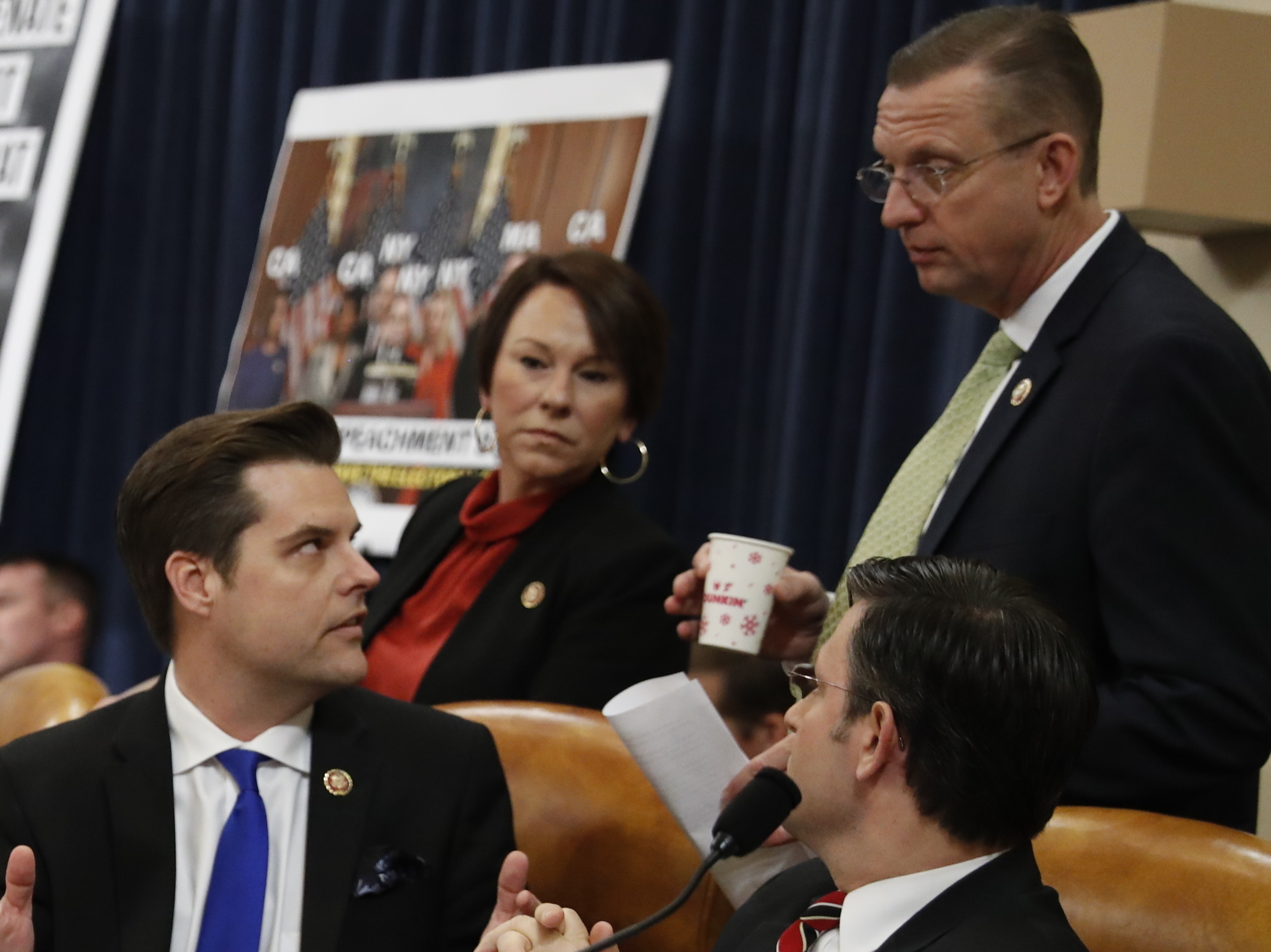Rep. Matt Gaetz, R-Fla., seated left center, talks Rep. Doug Collins, R-Ga., during a House Judiciary Committee markup in December. On Monday, both Gaetz and Collins said they were imposing self-quarantines after coming in contact with someone infected with coronavirus. (AP)