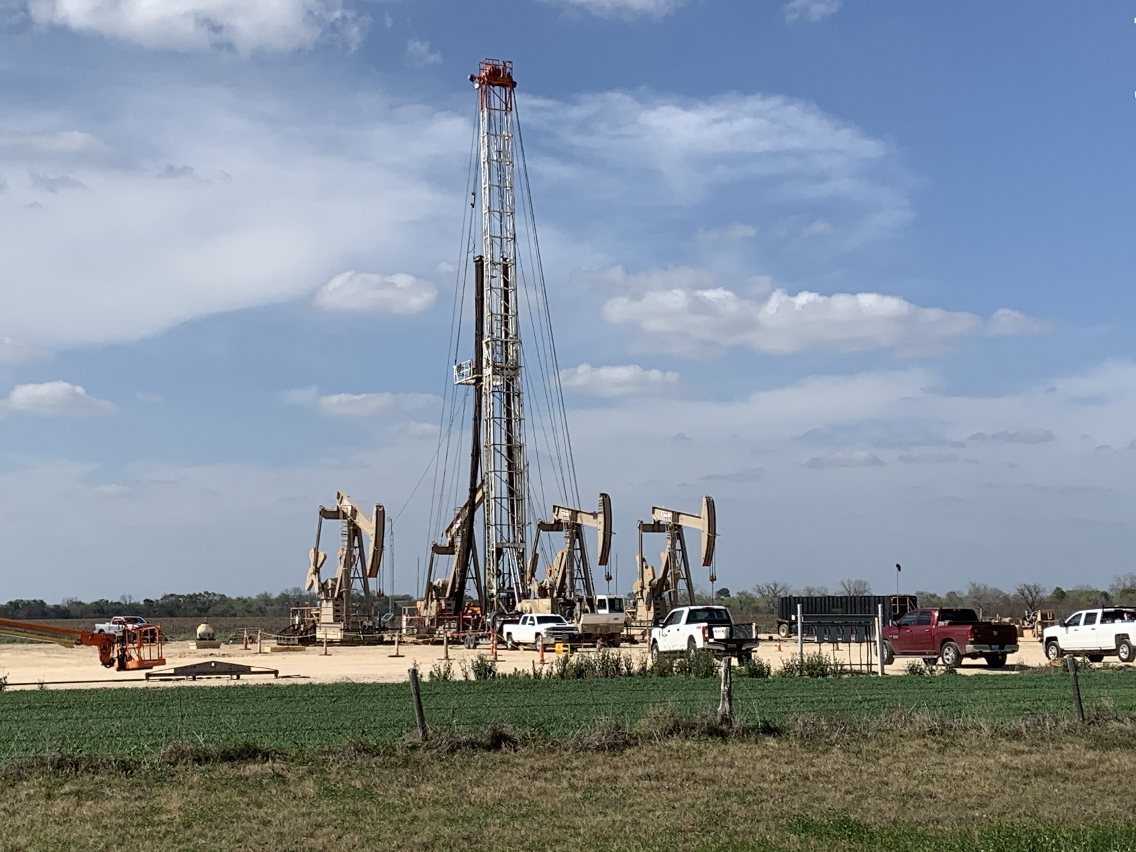 A crew near Karnes City, Texas, continued work as oil prices collapsed this week. Companies already were cutting costs and now will have to cut deeper as oil prices remain low. (NPR)