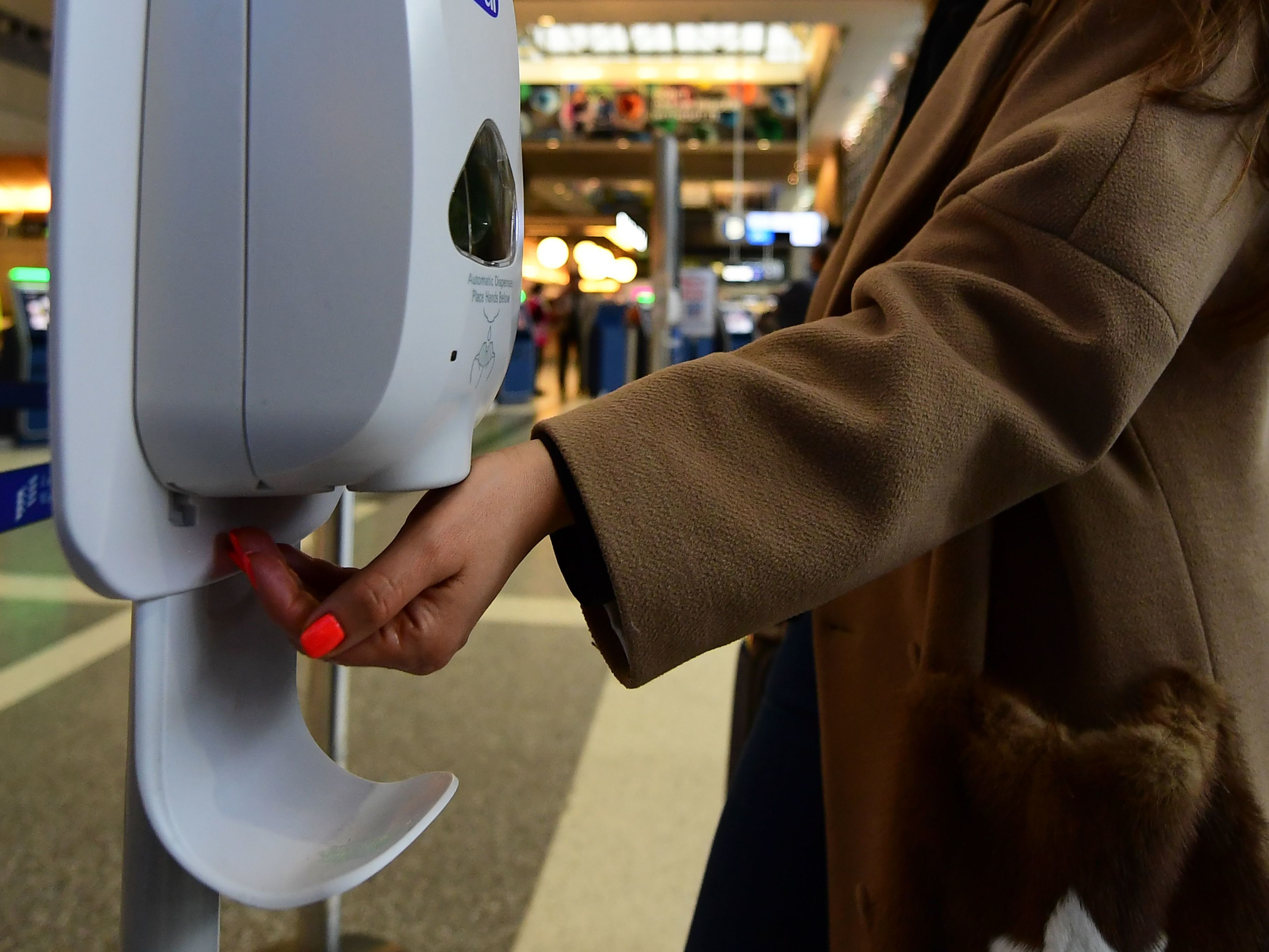 A woman uses hand sanitizer at Los Angeles International Airport on Thursday, the day before the start of the U.S. ban on travel from some European countries amid concern over the coronavirus. (AFP via Getty Images)