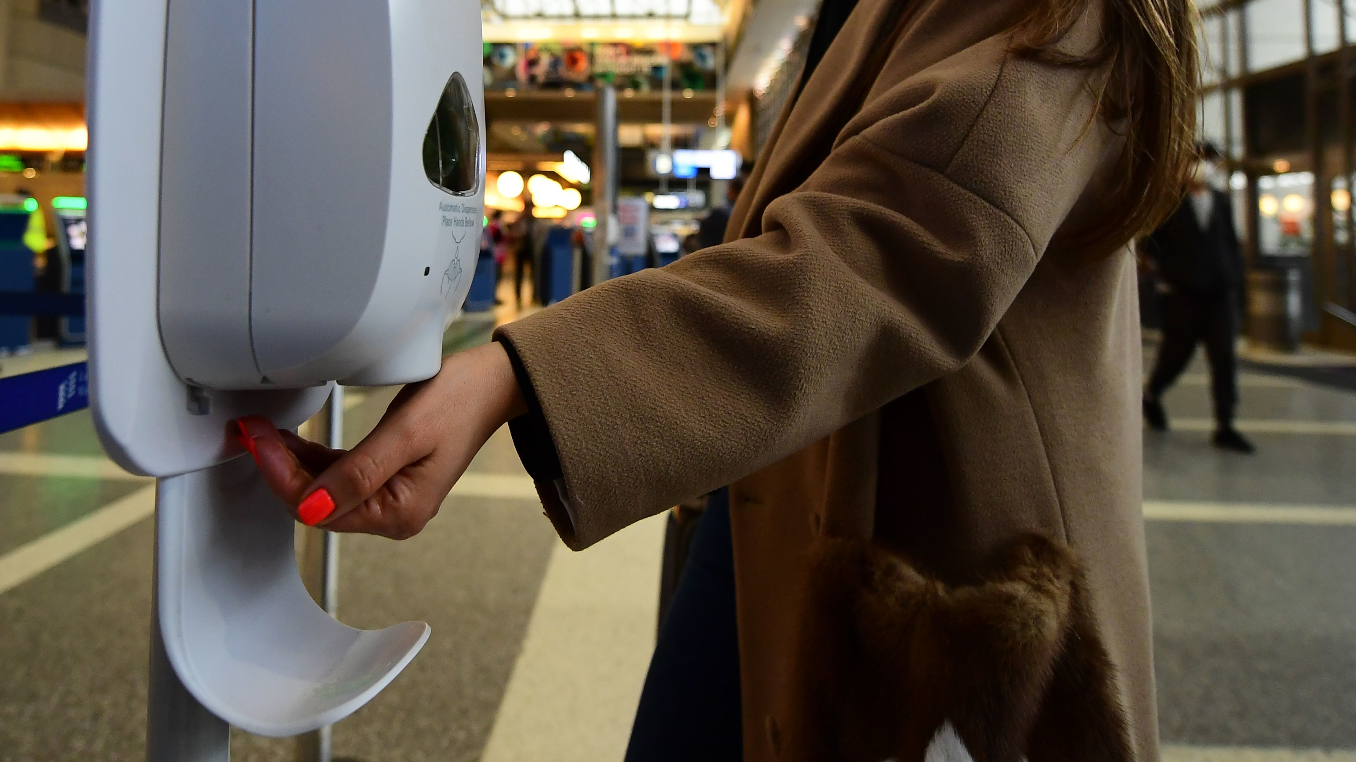 A woman uses hand sanitizer at Los Angeles International Airport on Thursday, the day before the start of the U.S. ban on travel from some European countries amid concern over the coronavirus.
