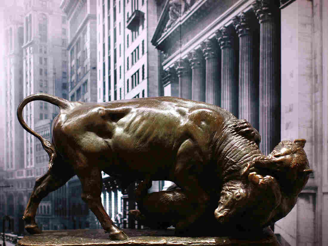 A bronze statue of a bull fighting with a bear.